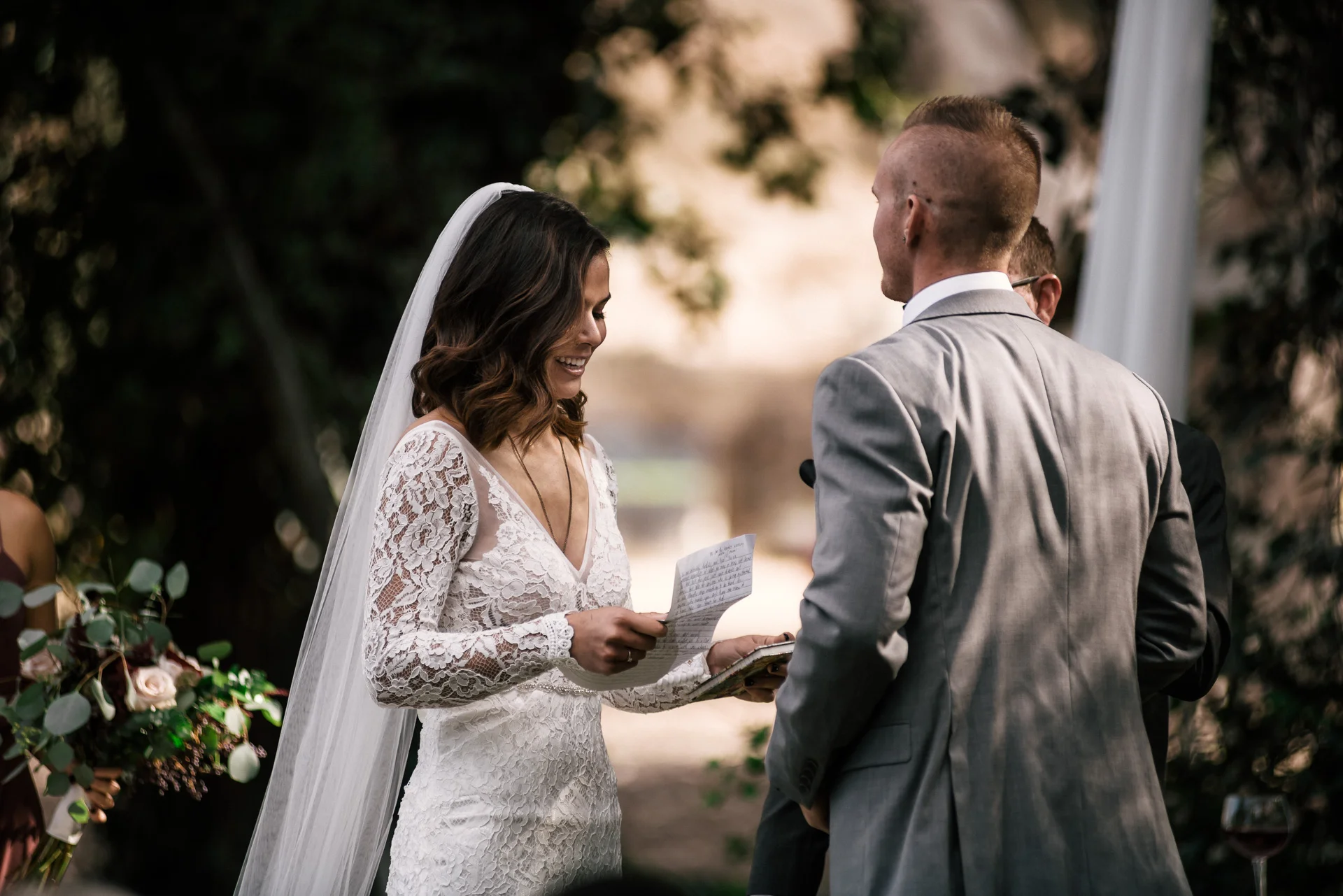 bride reads her vows during ceremony at rustic pymm ranch wedding venue in winchester california