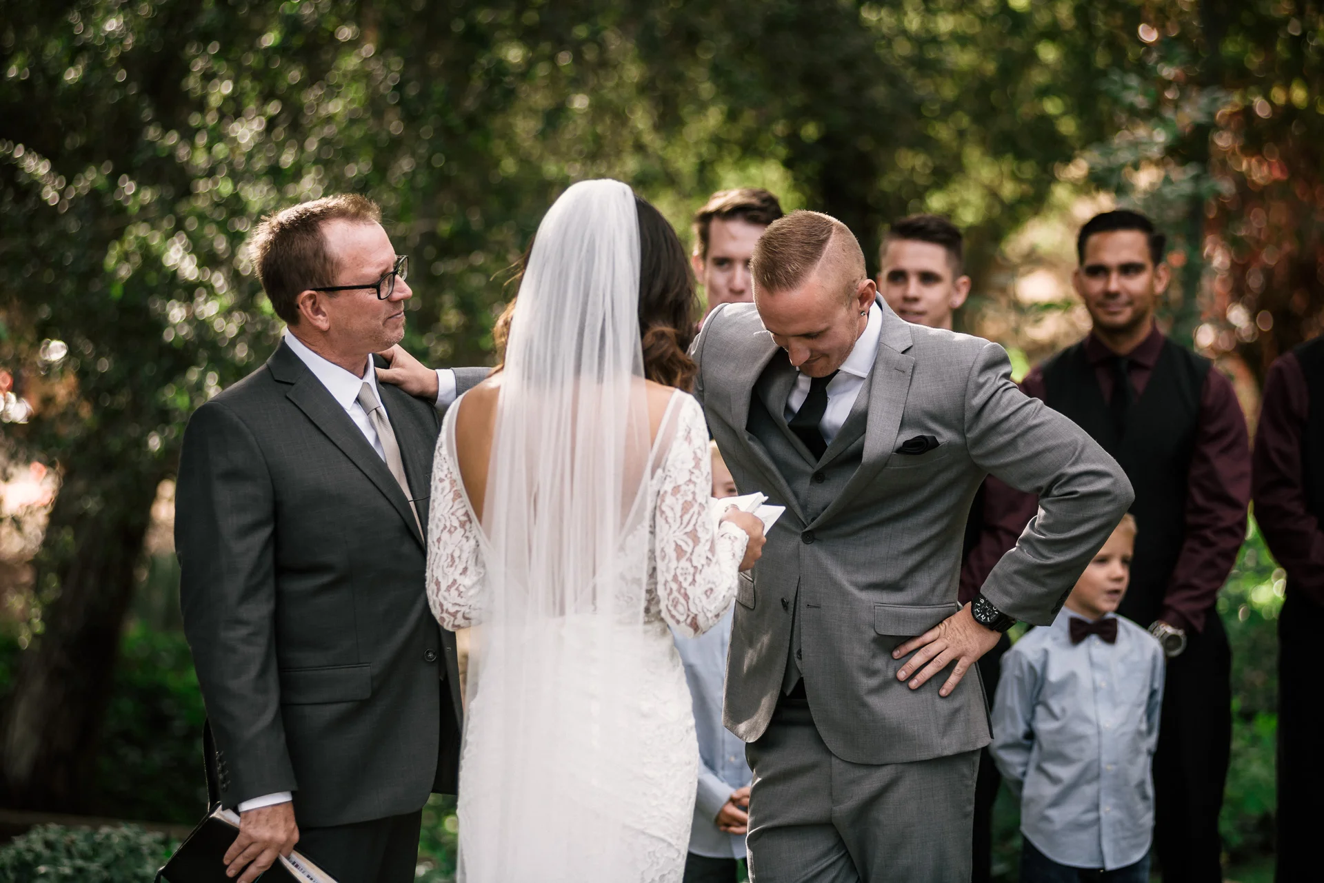 groom overcome with emotion holds on to father at rustic pymm ranch wedding venue in winchester california
