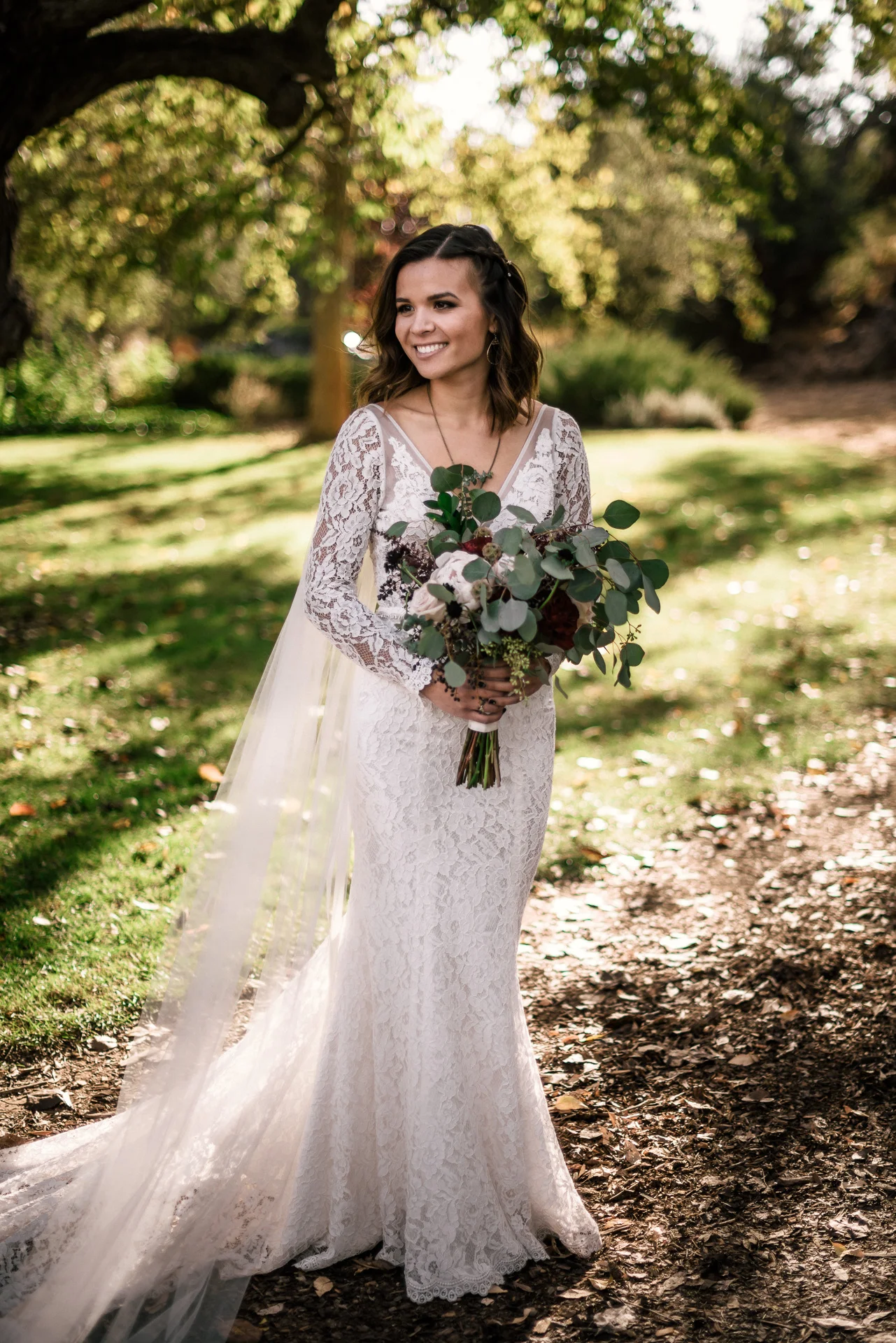 smile bride poses for portraits at rustic pymm ranch wedding venue in winchester california