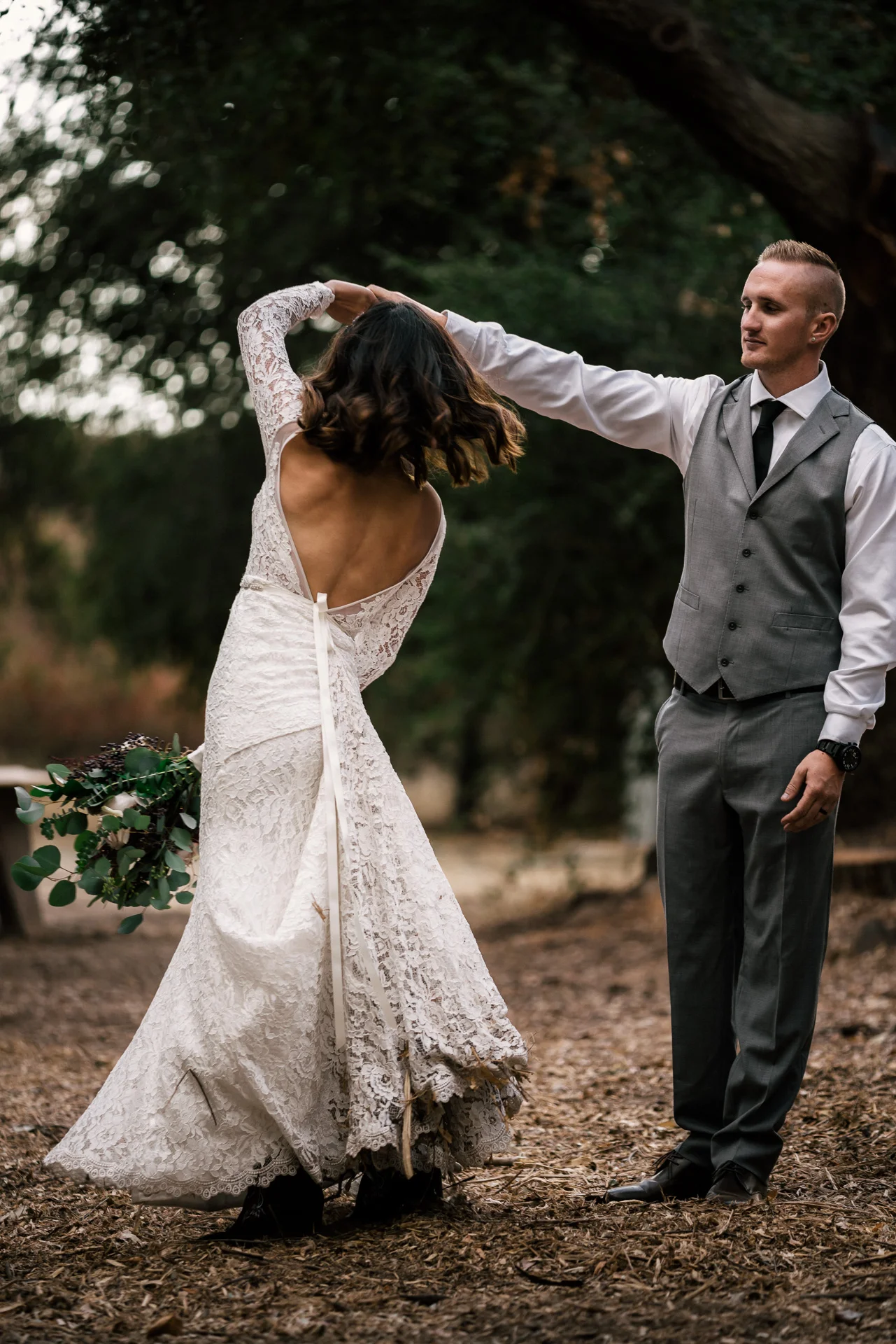 groom spins bride at rustic pymm ranch wedding venue in winchester california