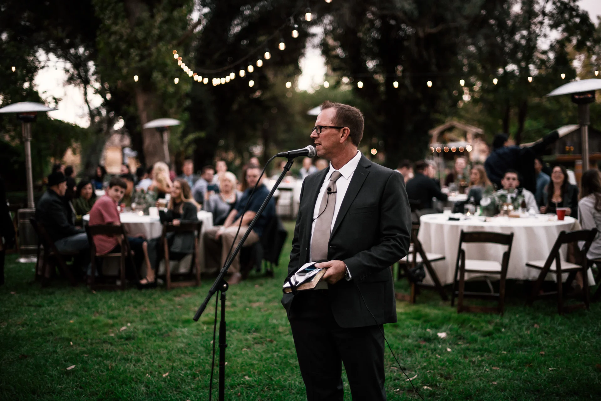 Father of the groom gives a speech at rustic pymm ranch wedding venue in winchester california