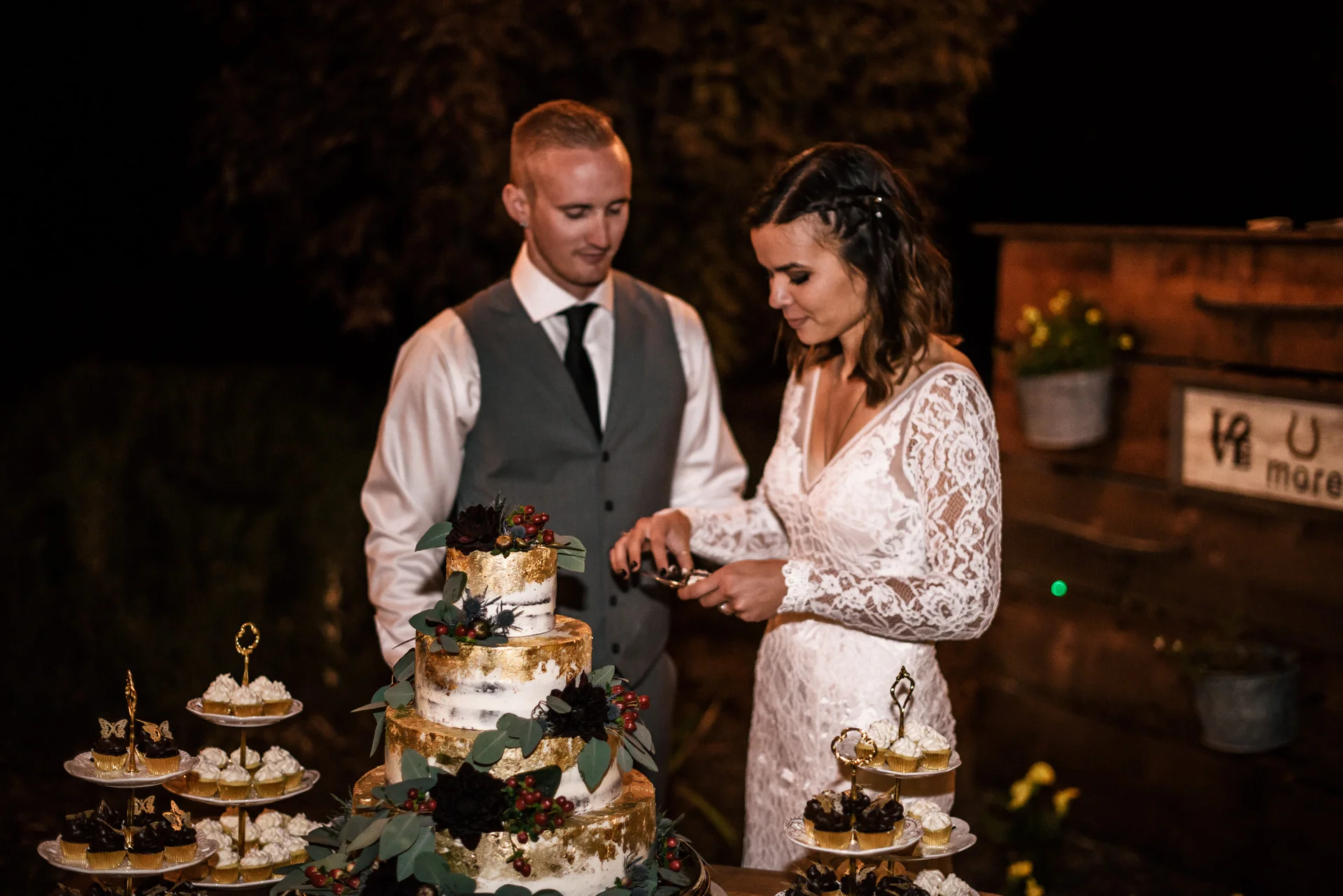 Bride and groom cut their cake at rustic pymm ranch wedding venue in winchester california