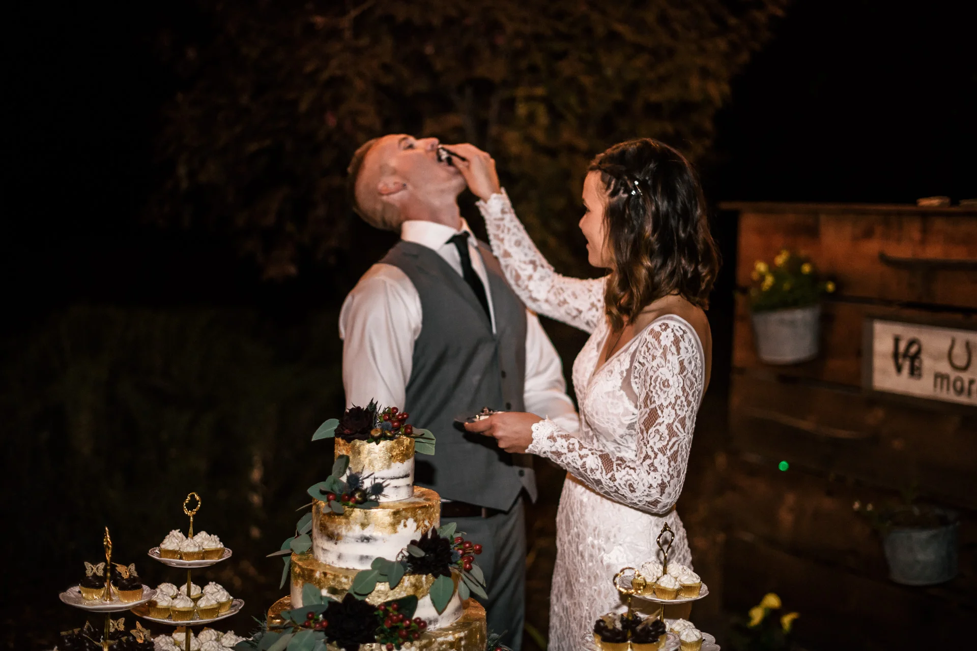Bride feeds her groom cake at rustic pymm ranch wedding venue in winchester california