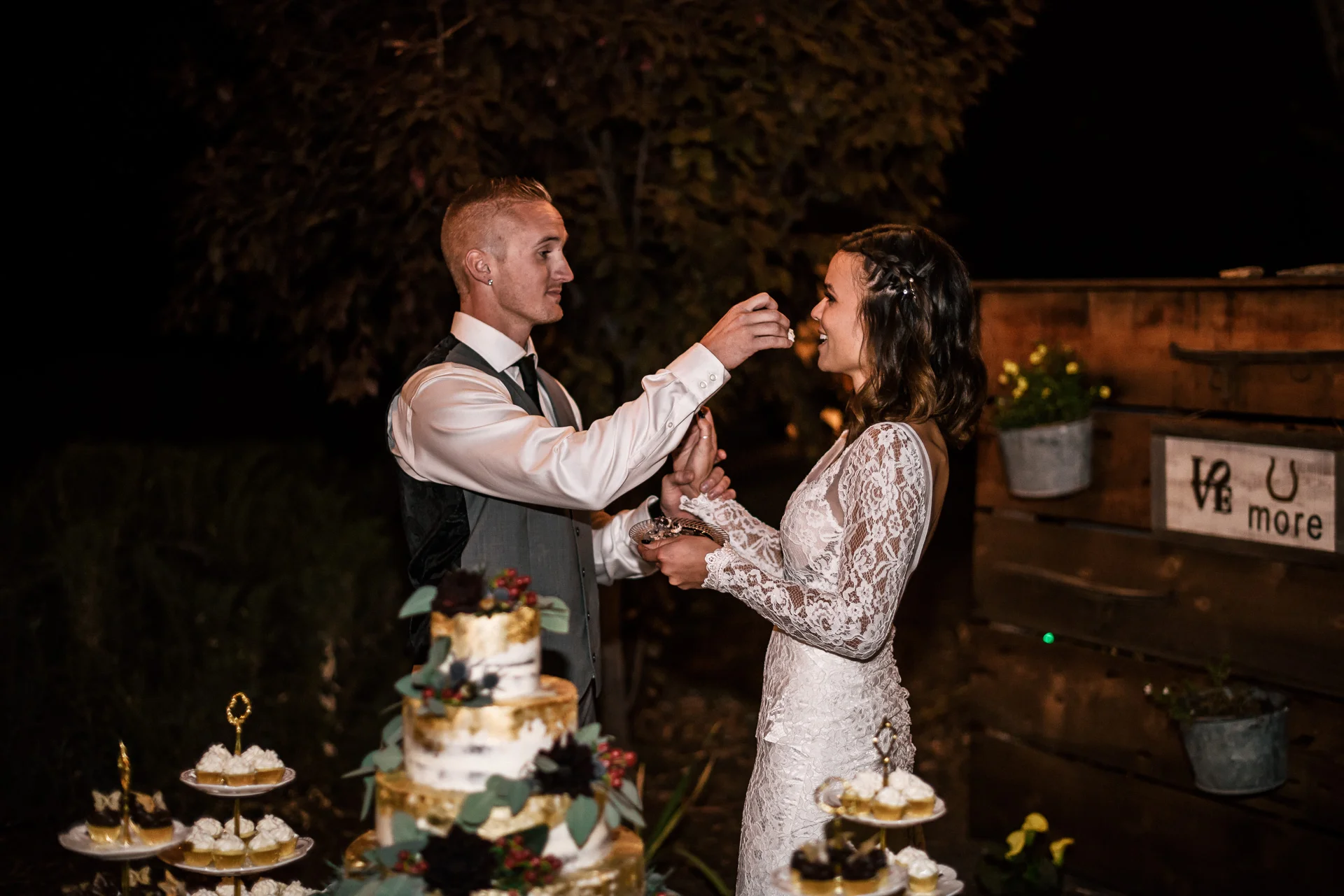 groom gives bride cake at rustic pymm ranch wedding venue in winchester california