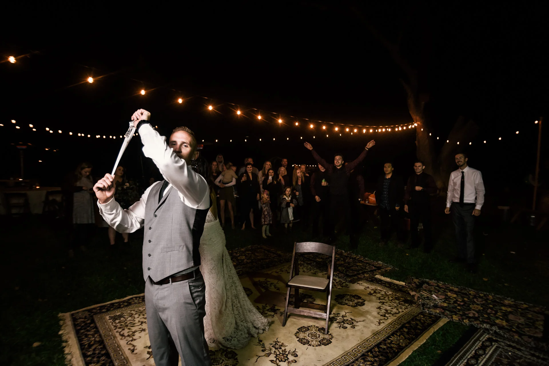 groom prepares to launch garter at rustic pymm ranch wedding venue in winchester california