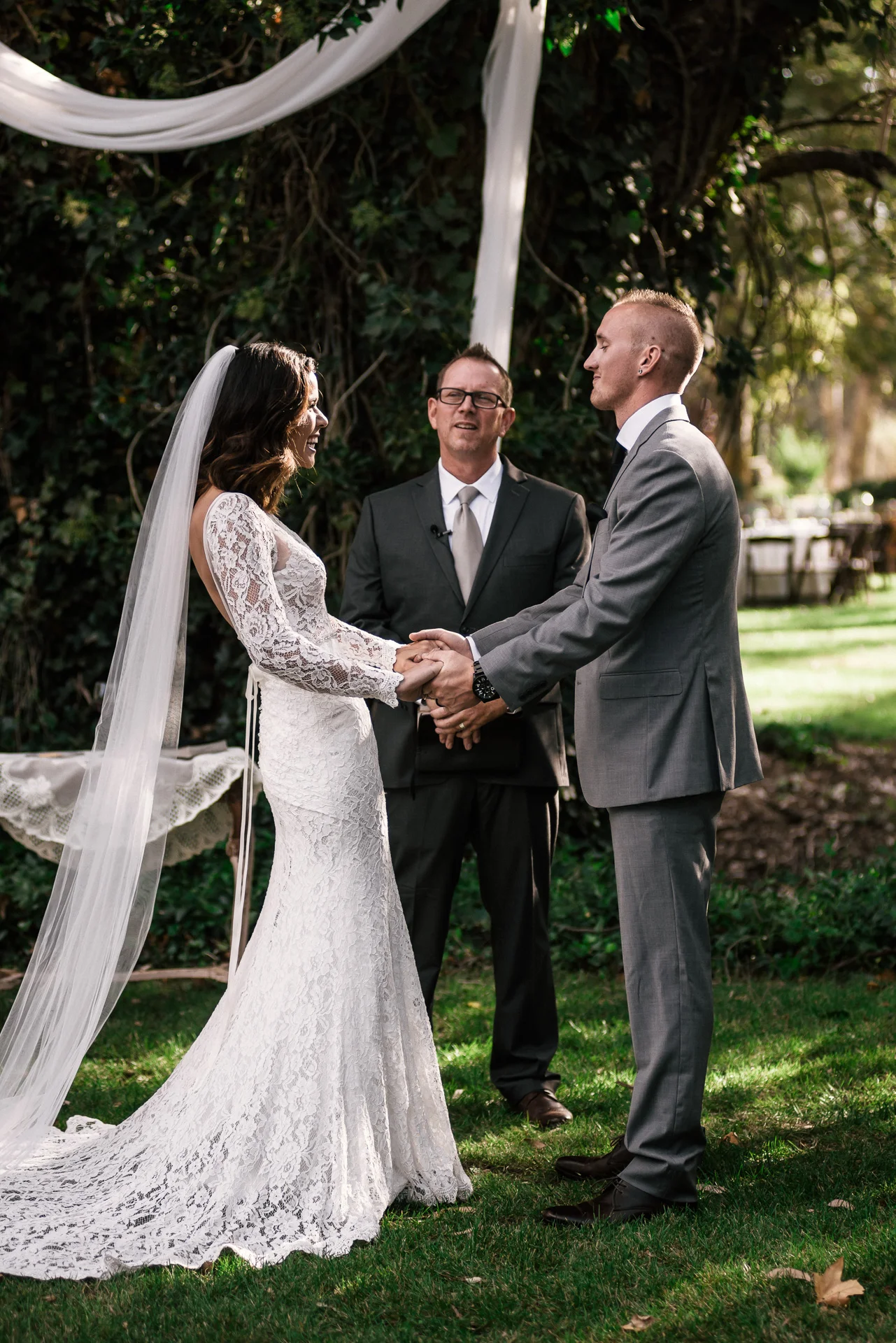 bride and groom prepare for their first kiss at rustic pymm ranch wedding venue in winchester california