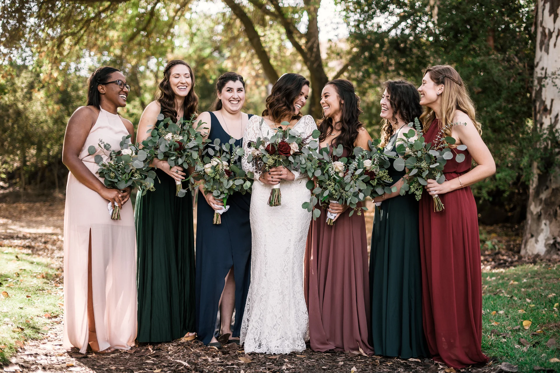 laughing bride and her bridesmaids with eucolyptus bouquet at rustic pymm ranch wedding venue in winchester california