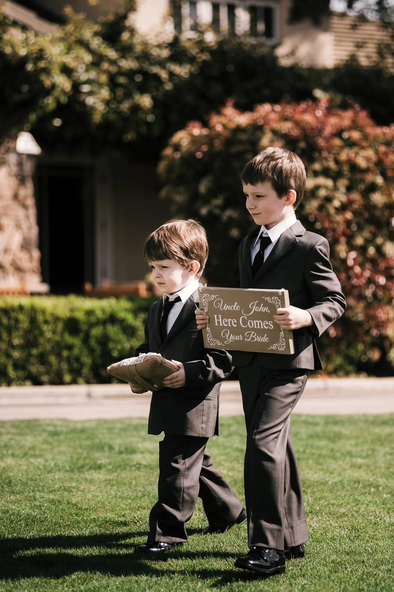 ring bearers walk down the aisle announcing the bride at the Twin Oaks Golf Course in San Marcos, San Diegos premier wedding venue