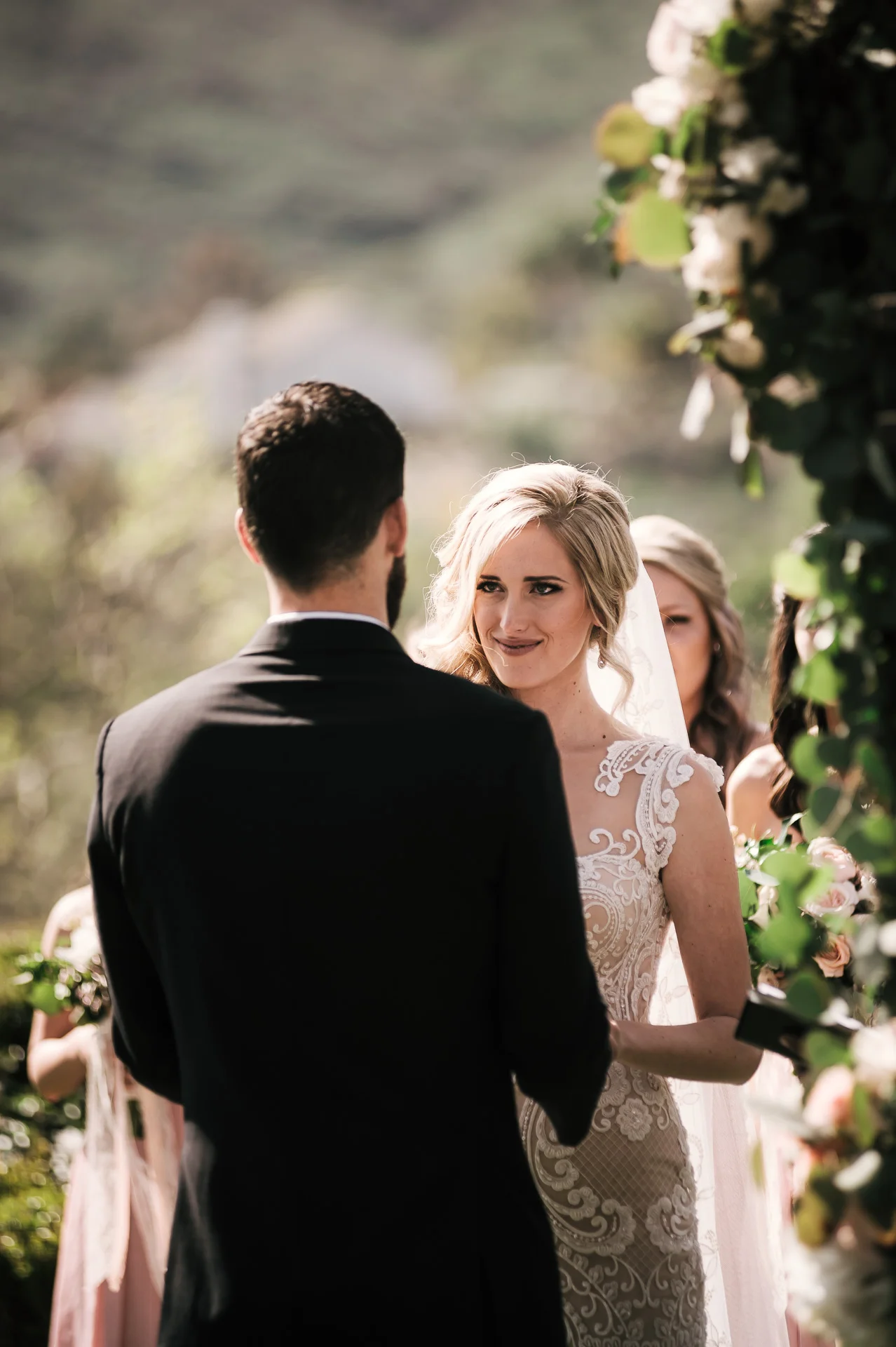 brides eyes full of emotion as she looks at groom saying his vows at the Twin Oaks Golf Course in San Marcos, San Diegos premier wedding venue