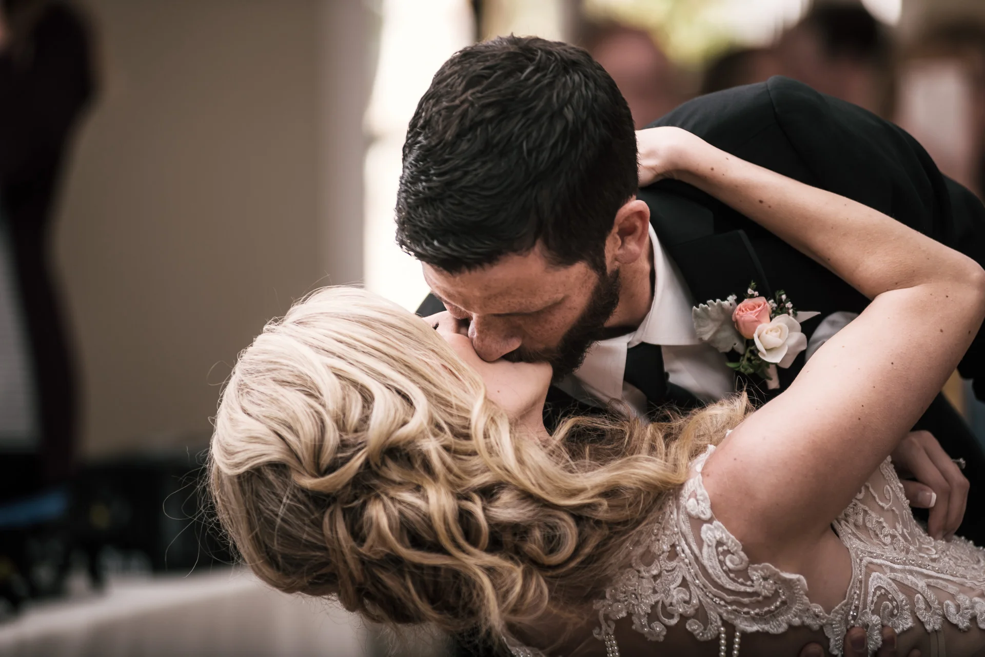 groom gives his bride a kiss while diping her at the Twin Oaks Golf Course in San Marcos, San Diegos premier wedding venue