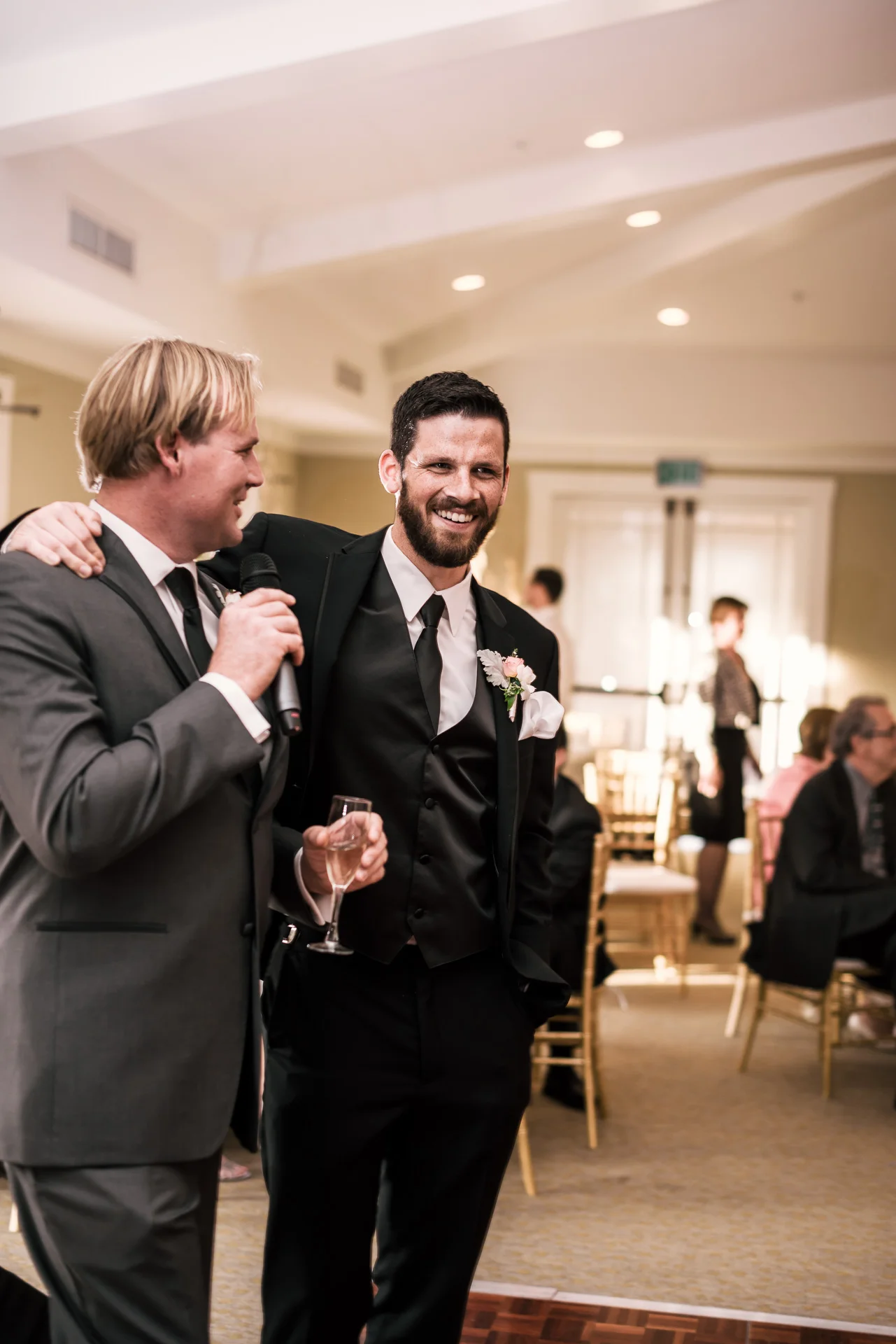 groom puts his arm around bestman as he gives a toast at the Twin Oaks Golf Course in San Marcos, San Diegos premier wedding venue