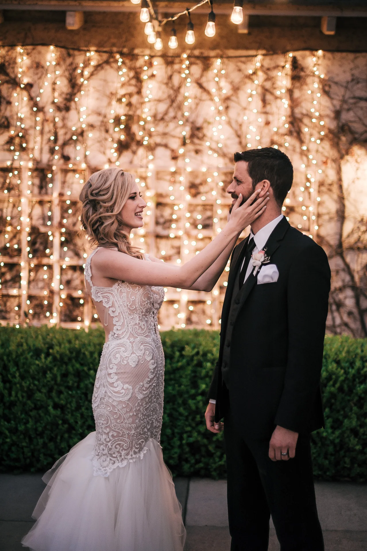 bride holds her grooms face at the Twin Oaks Golf Course in San Marcos, San Diegos premier wedding venue