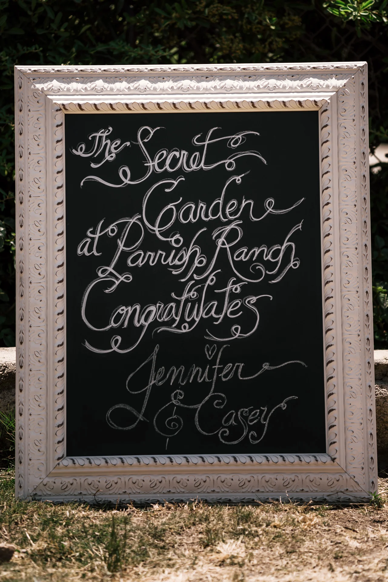 chalk wedding sign at the secret garden located at the Historic Parish ranch in Oak Glen California