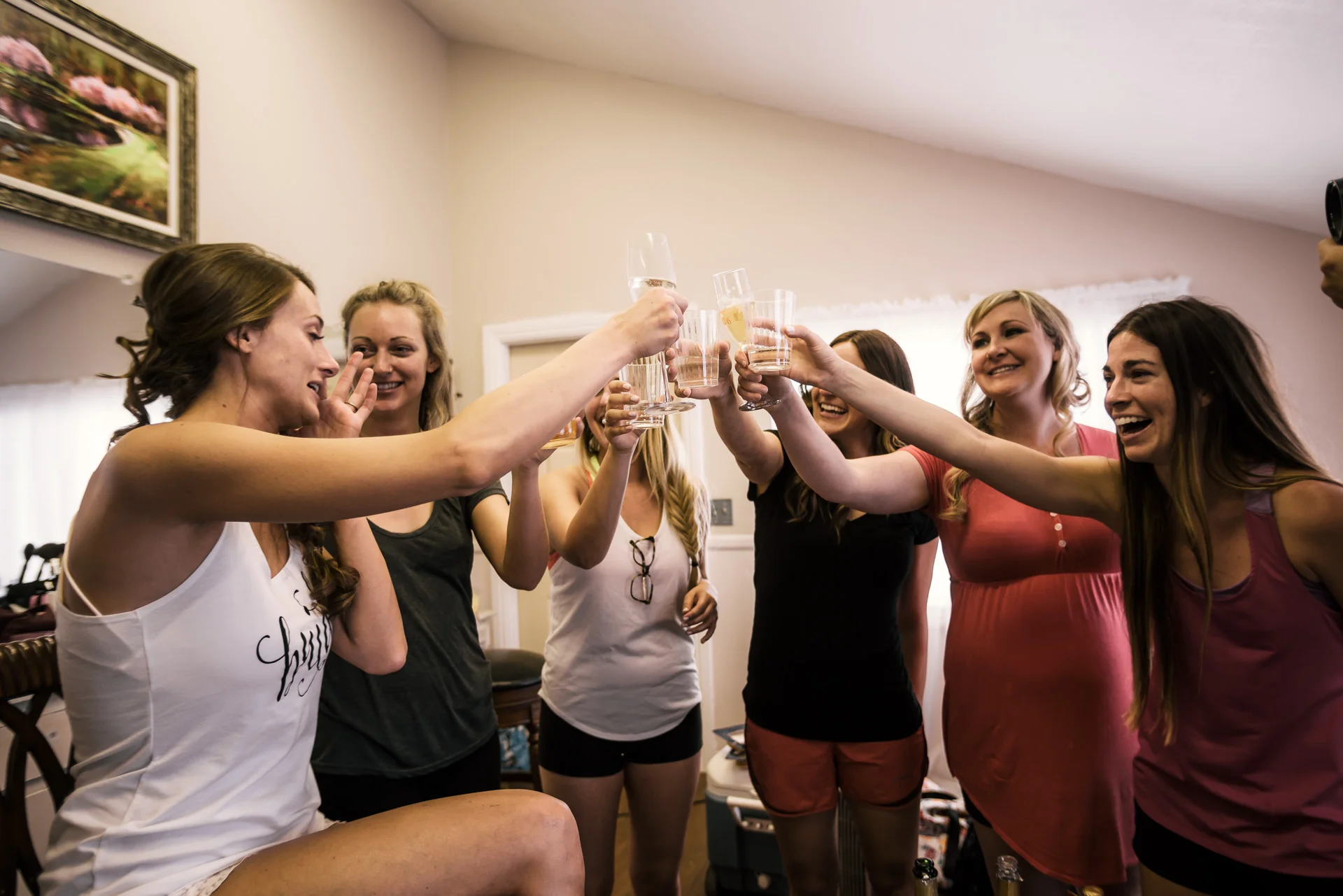 bride has a drink with her bridesmaids at the secret garden located at the Historic Parish ranch in Oak Glen California