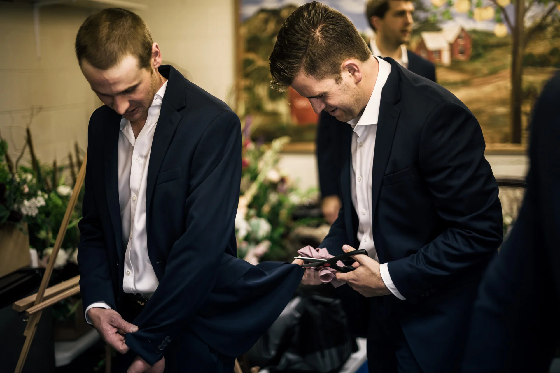 groom lends his groomsmen a hand at the secret garden located at the Historic Parish ranch in Oak Glen California