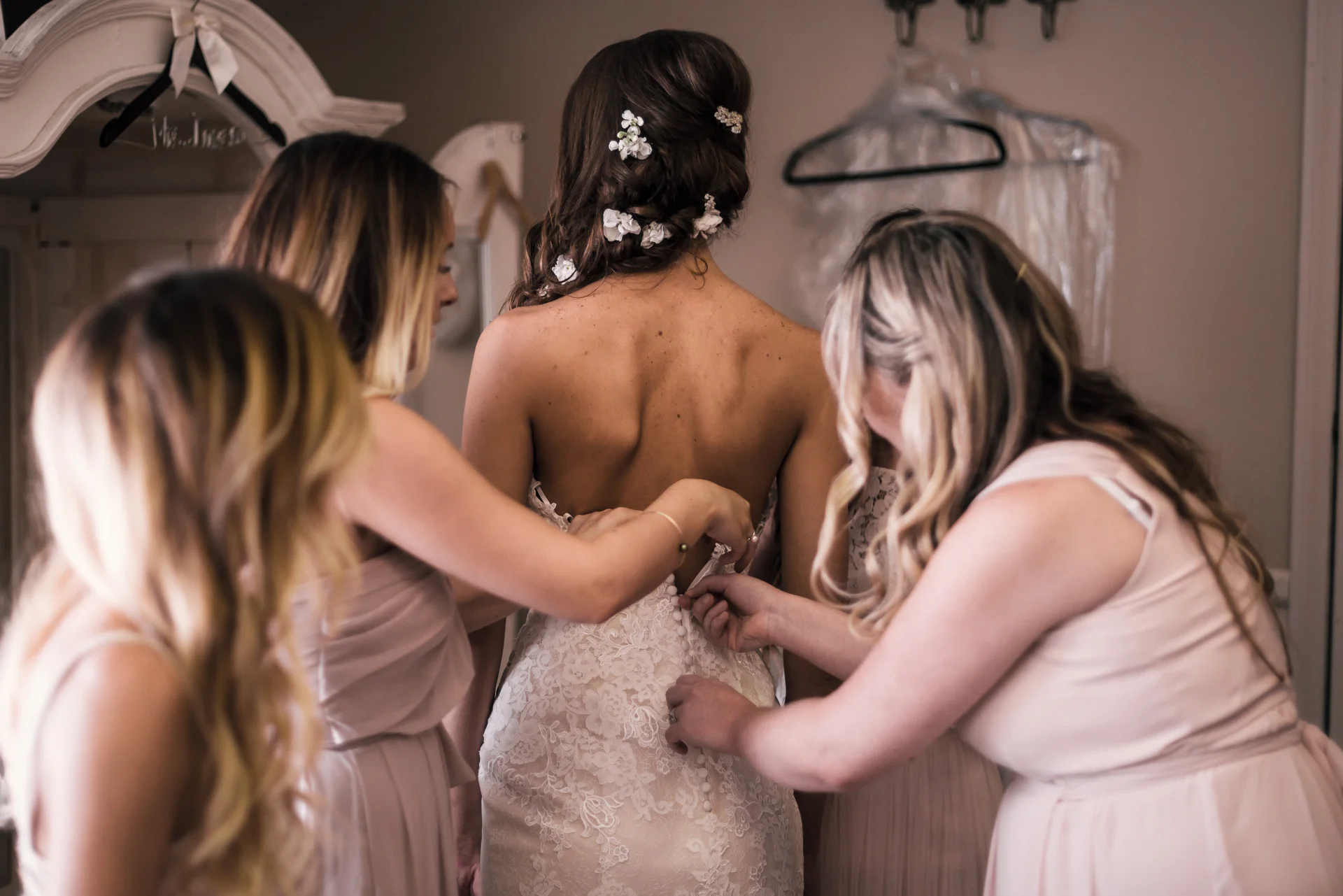 Bridesmaids button up brides wedding dress at the secret garden located at the Historic Parish ranch in Oak Glen California