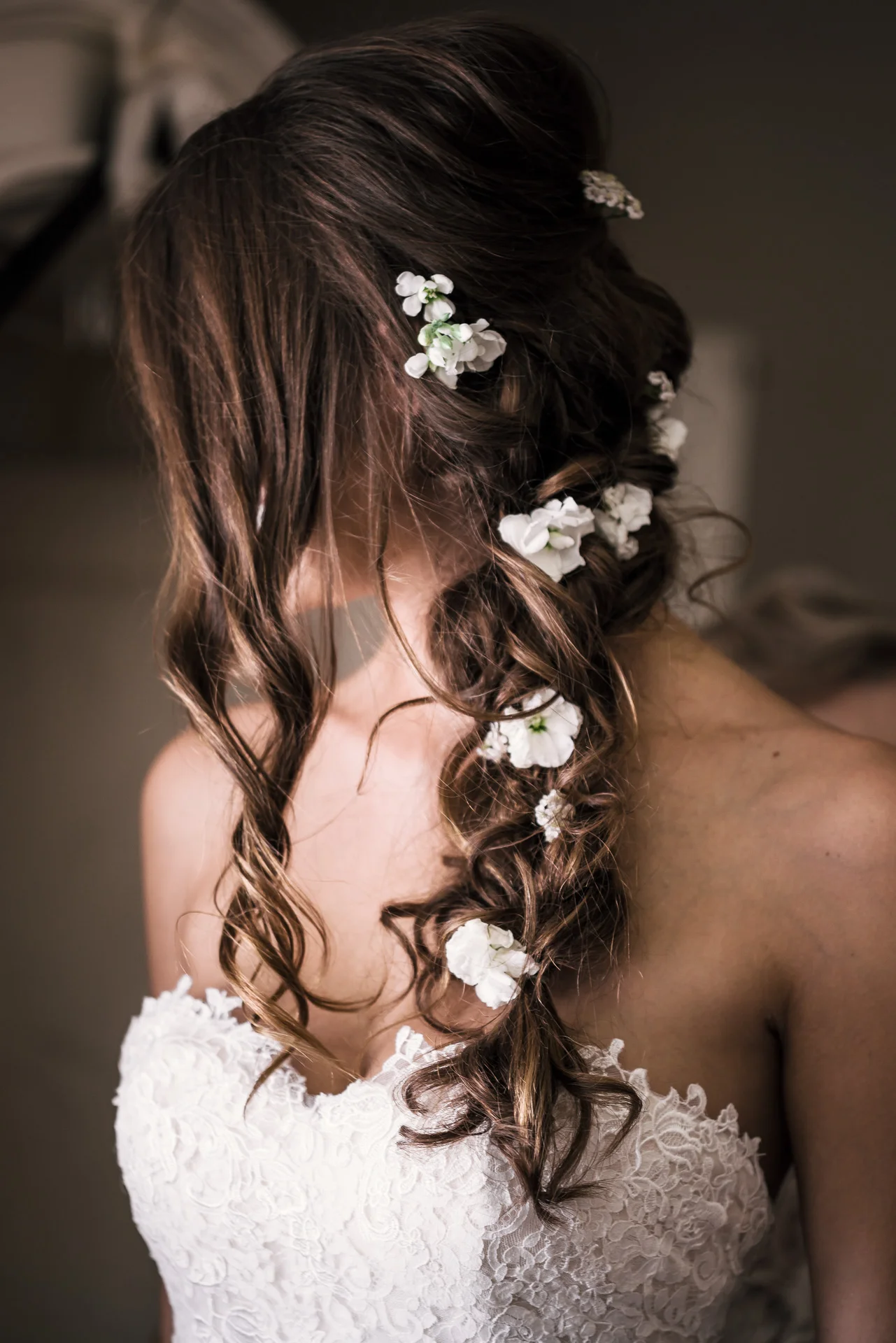 Bride in her wedding dress has flowers in her hair at the secret garden located at the Historic Parish ranch in Oak Glen California