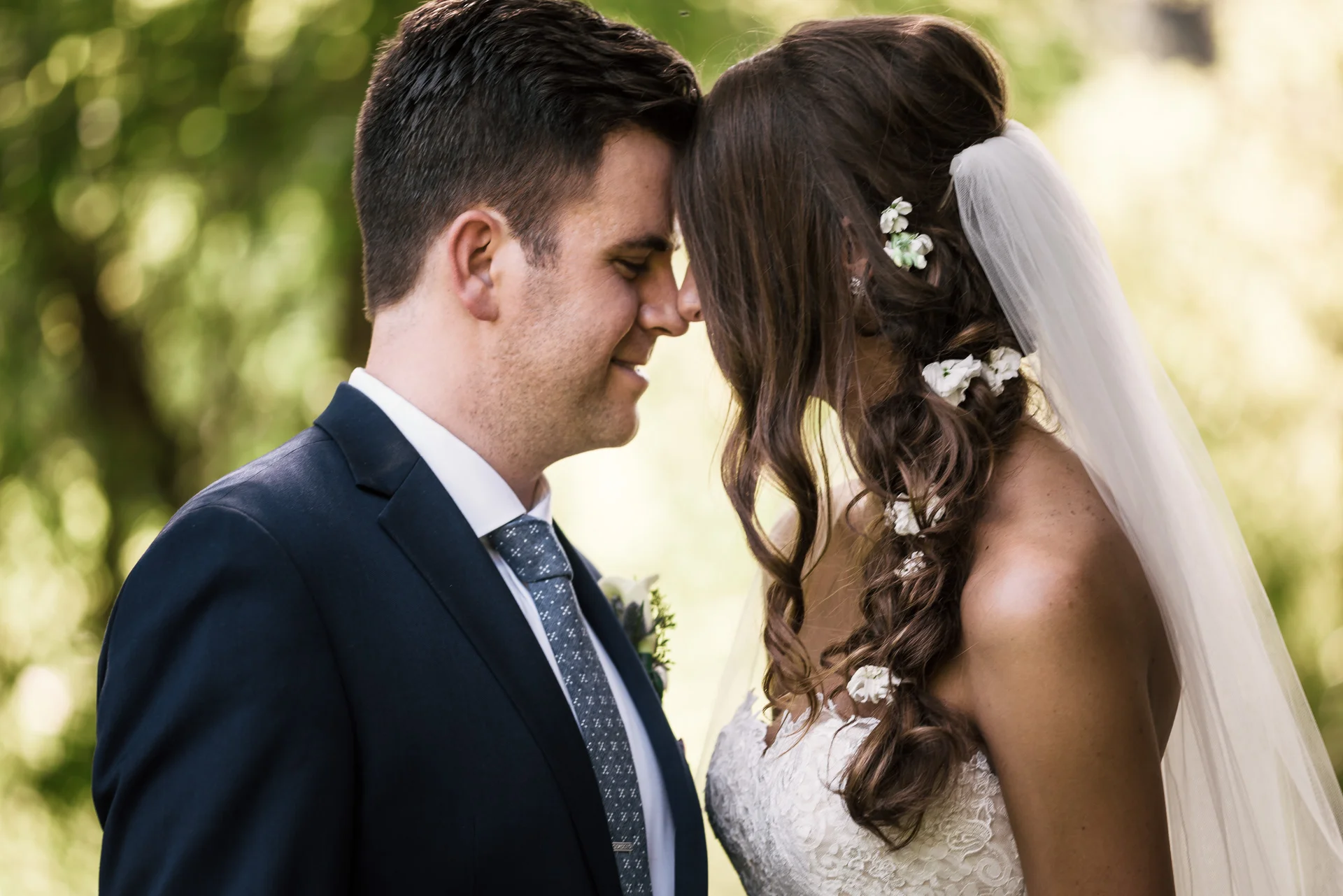 bride and groom share a tender moment togeather at the secret garden located at the Historic Parish ranch in Oak Glen California