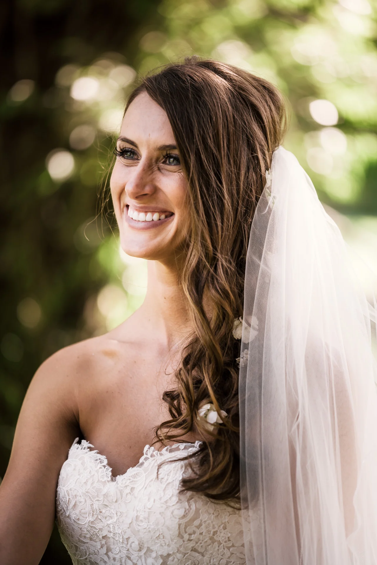bride is all smiles as she looks at her groom at the secret garden located at the Historic Parish ranch in Oak Glen California