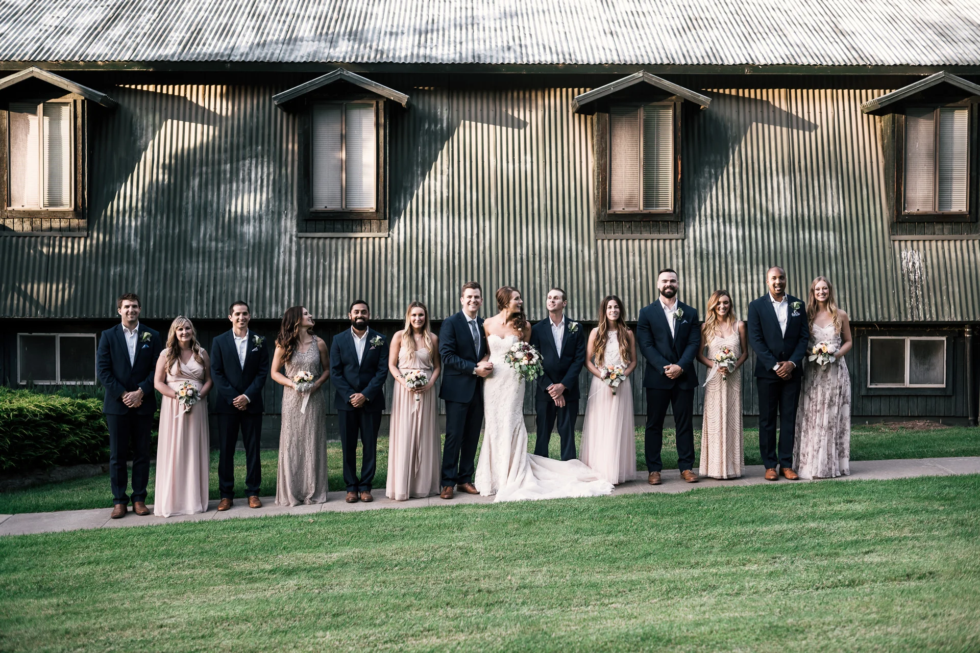 bridal party lines up for photos at the secret garden located at the Historic Parish ranch in Oak Glen California