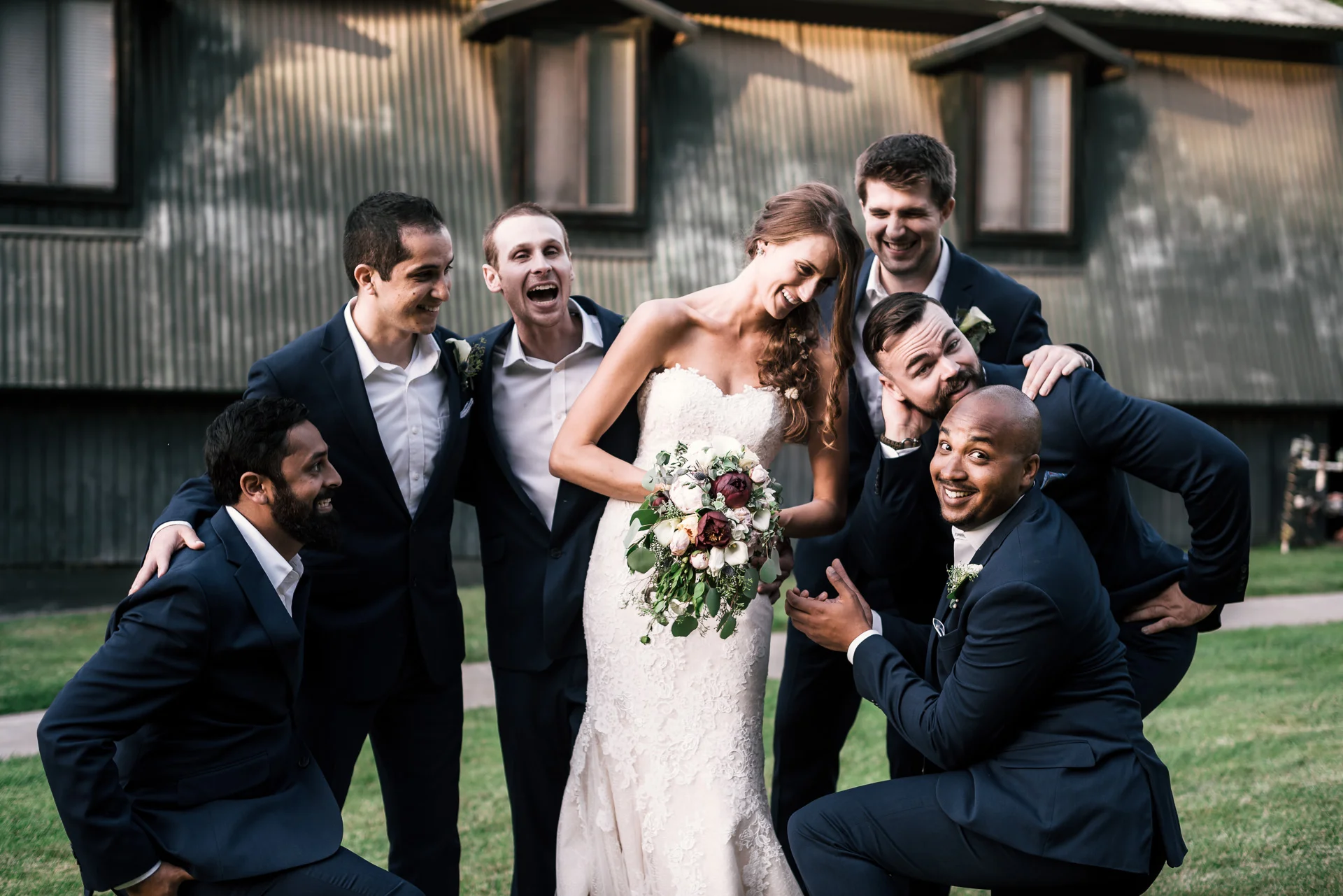 groomsmen goof off with the bride at the secret garden located at the Historic Parish ranch in Oak Glen California