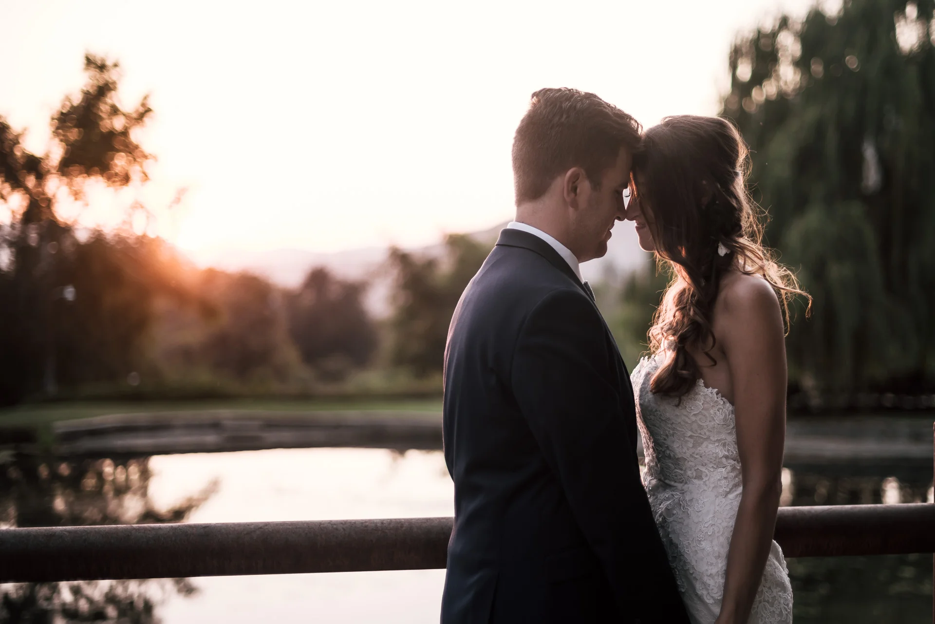 bride and groom get close at the secret garden located at the Historic Parish ranch in Oak Glen California