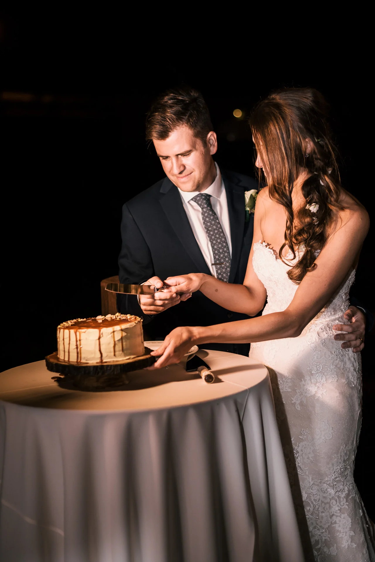 bride and groom cut the wedding cake at the secret garden located at the Historic Parish ranch in Oak Glen California