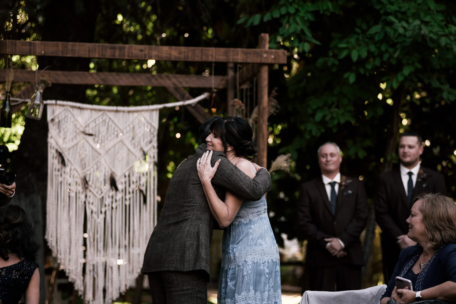 groom hugs his mother in law shot by wedding photographer at the charming St. George Hotel in Volcano California