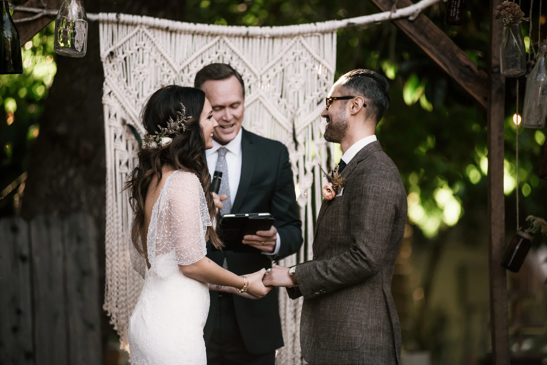 Bride and groom laugh at pastors joke shot by wedding photographer at the charming St. George Hotel in Volcano California