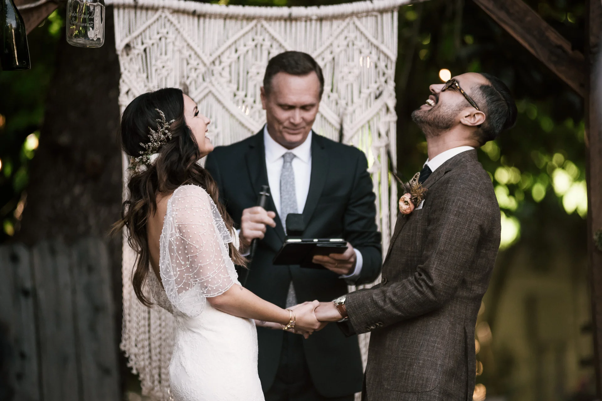 couple shares a big laugh during their ceremony shot by wedding photographer at the charming St. George Hotel in Volcano California