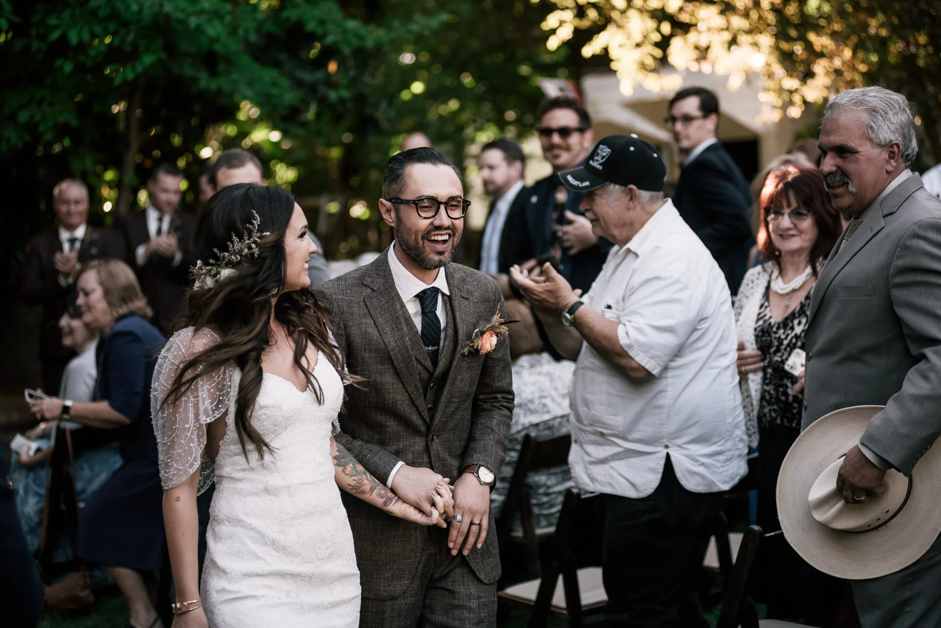 bride and groom walk down the aisle as husband and wife shot by wedding photographer at the charming St. George Hotel in Volcano California