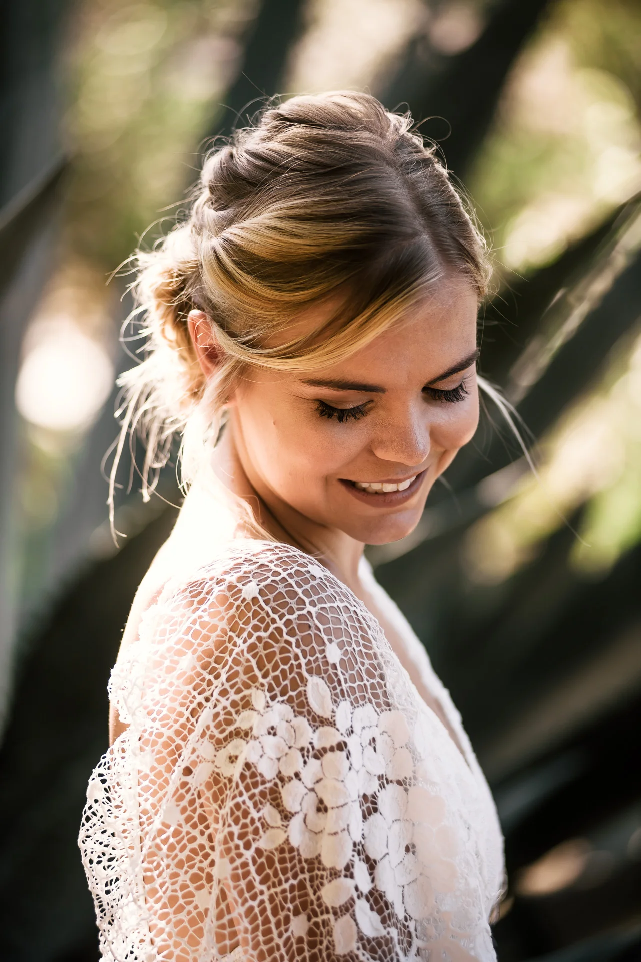 bashful bride poses for a portrait captured by photographer during romantic wedding at the historic Leo Carrillo Ranch in Carlsbad California