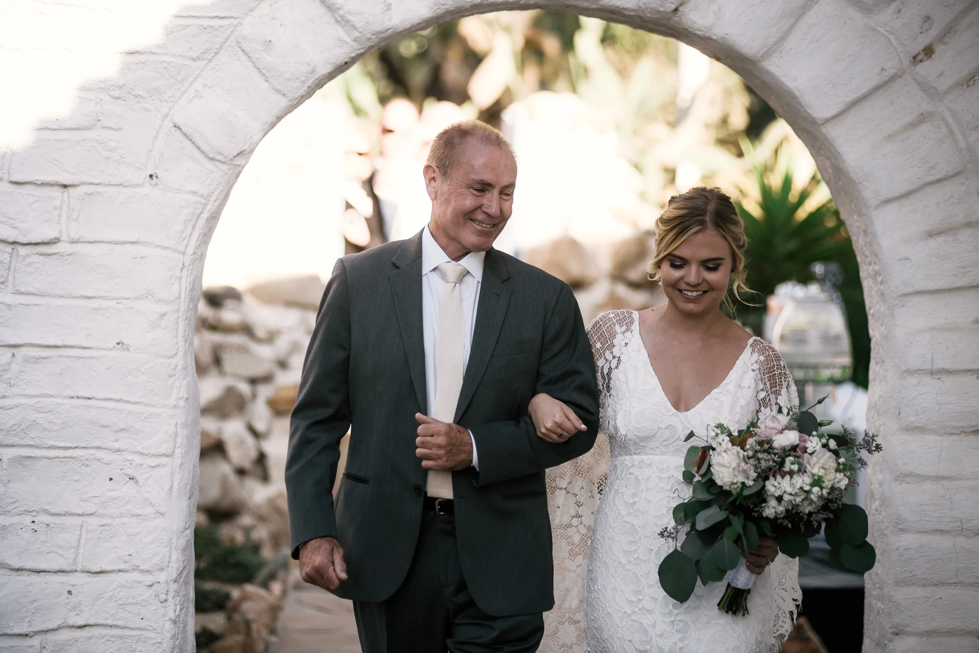 Father walks his daughter down the aisle captured by photographer during romantic wedding at the historic Leo Carrillo Ranch in Carlsbad California