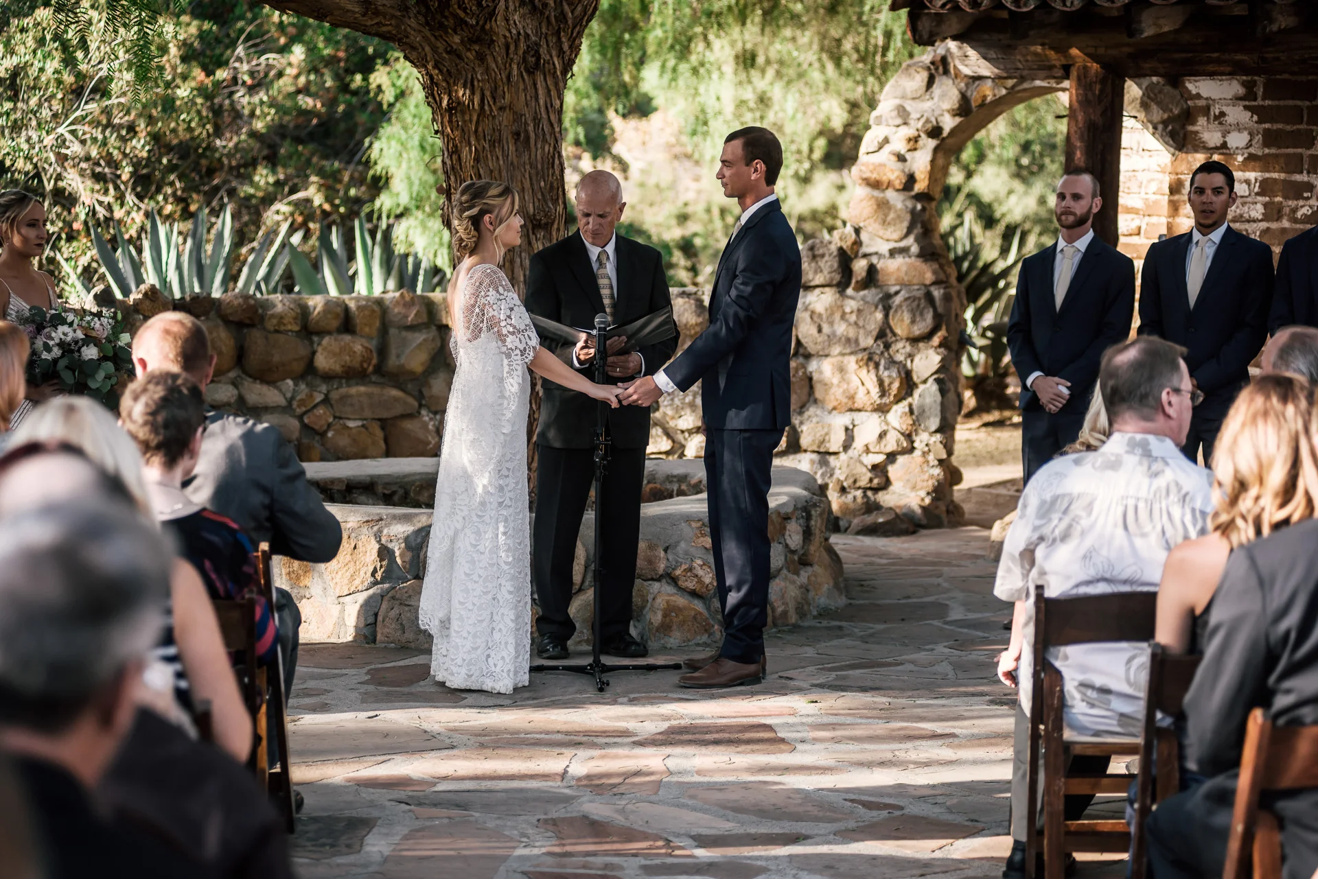 bride and groom prepare to say their vows captured by photographer during romantic wedding at the historic Leo Carrillo Ranch in Carlsbad California