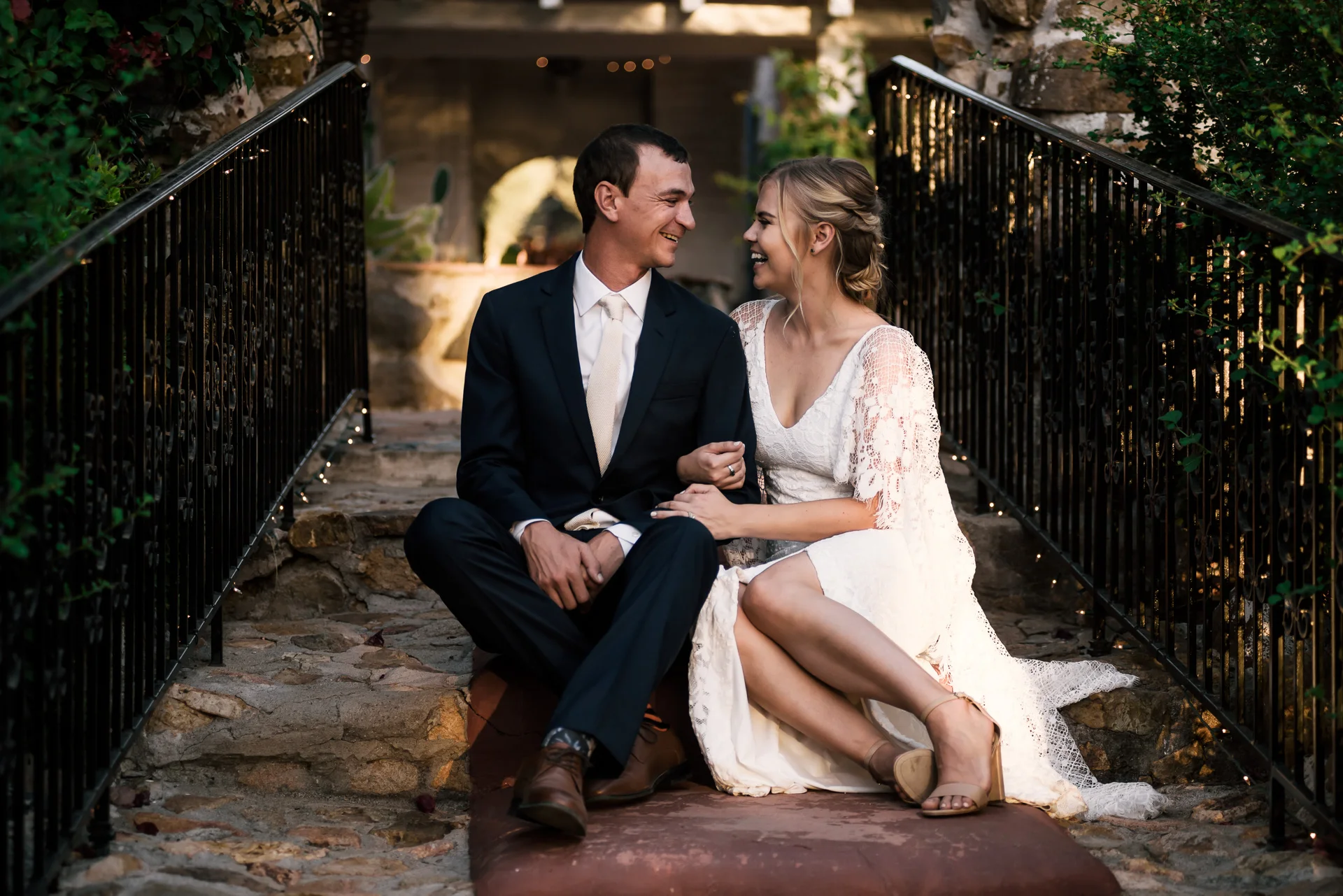 bride and groom sit for a moment and enjoy each others company captured by photographer during romantic wedding at the historic Leo Carrillo Ranch in Carlsbad California