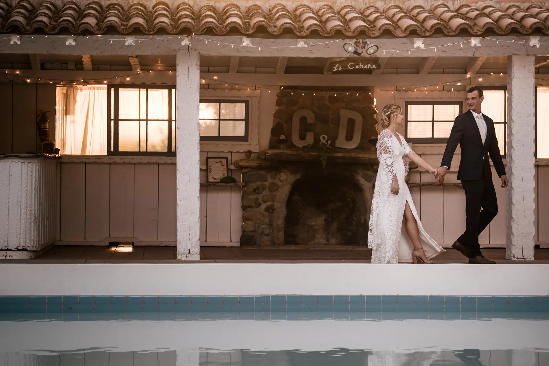 couple goes on a romantic walk captured by photographer during romantic wedding at the historic Leo Carrillo Ranch in Carlsbad California