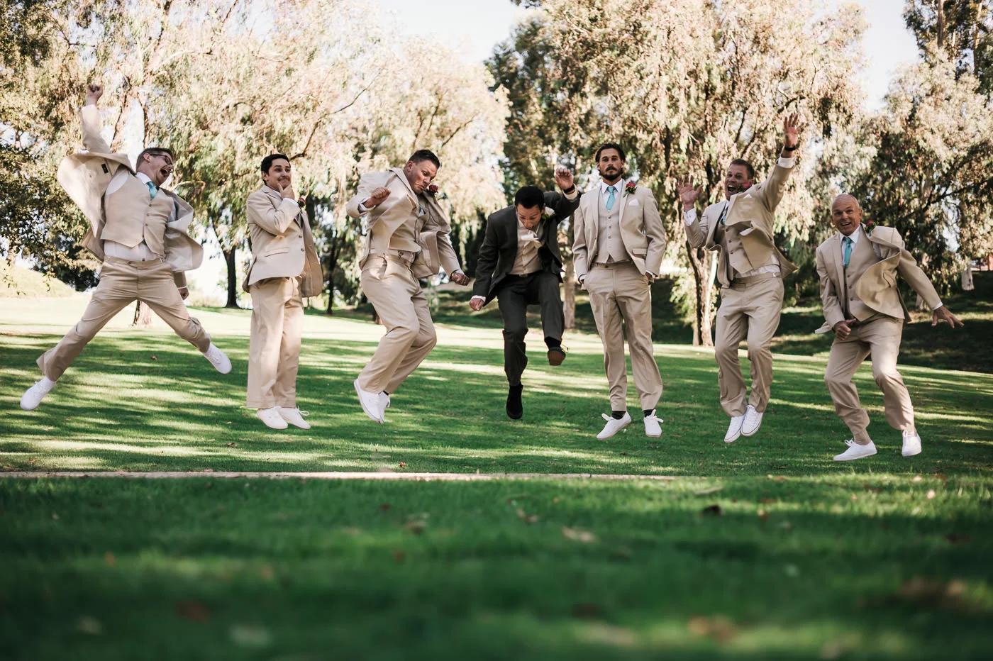 Groom has a blast jumping with his groomsmen before the marriage ceremony.