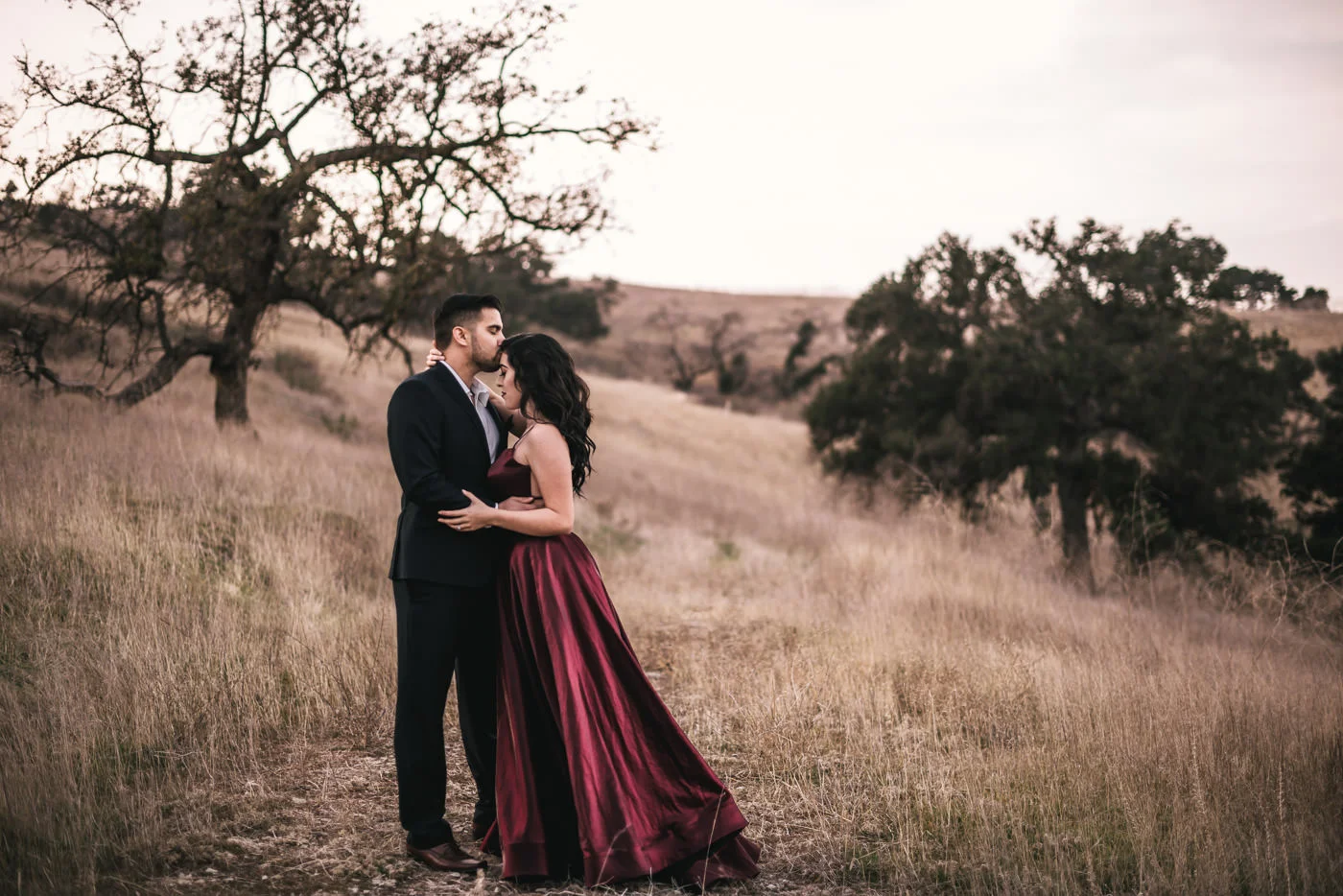 Couple has a sweet moment before their wedding in the fields of Malibu.