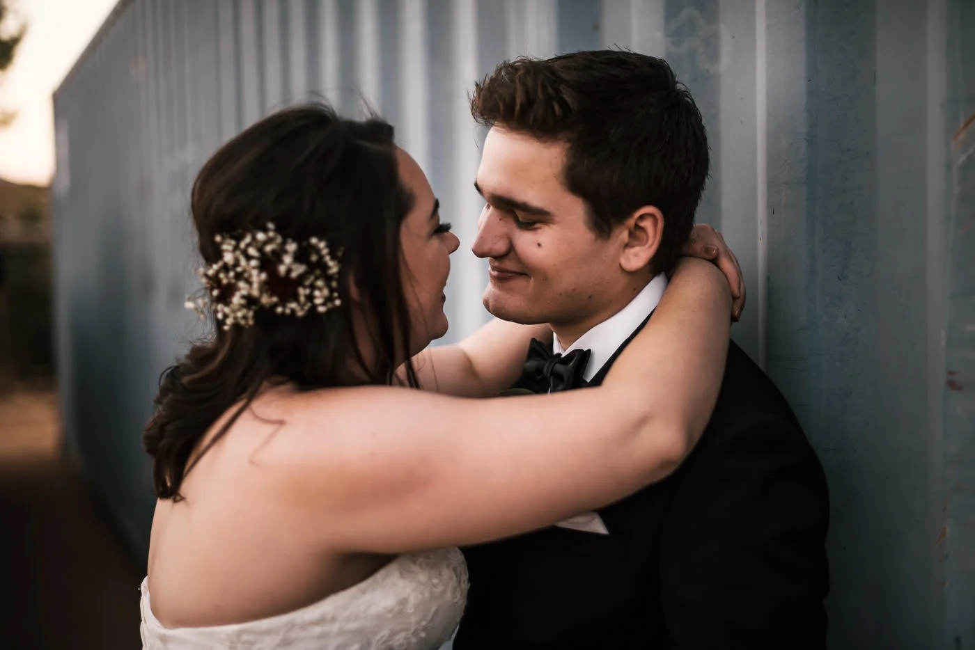 Groom looks lovingly at his bride as they share a romantic moment at their country wedding in Temecula.