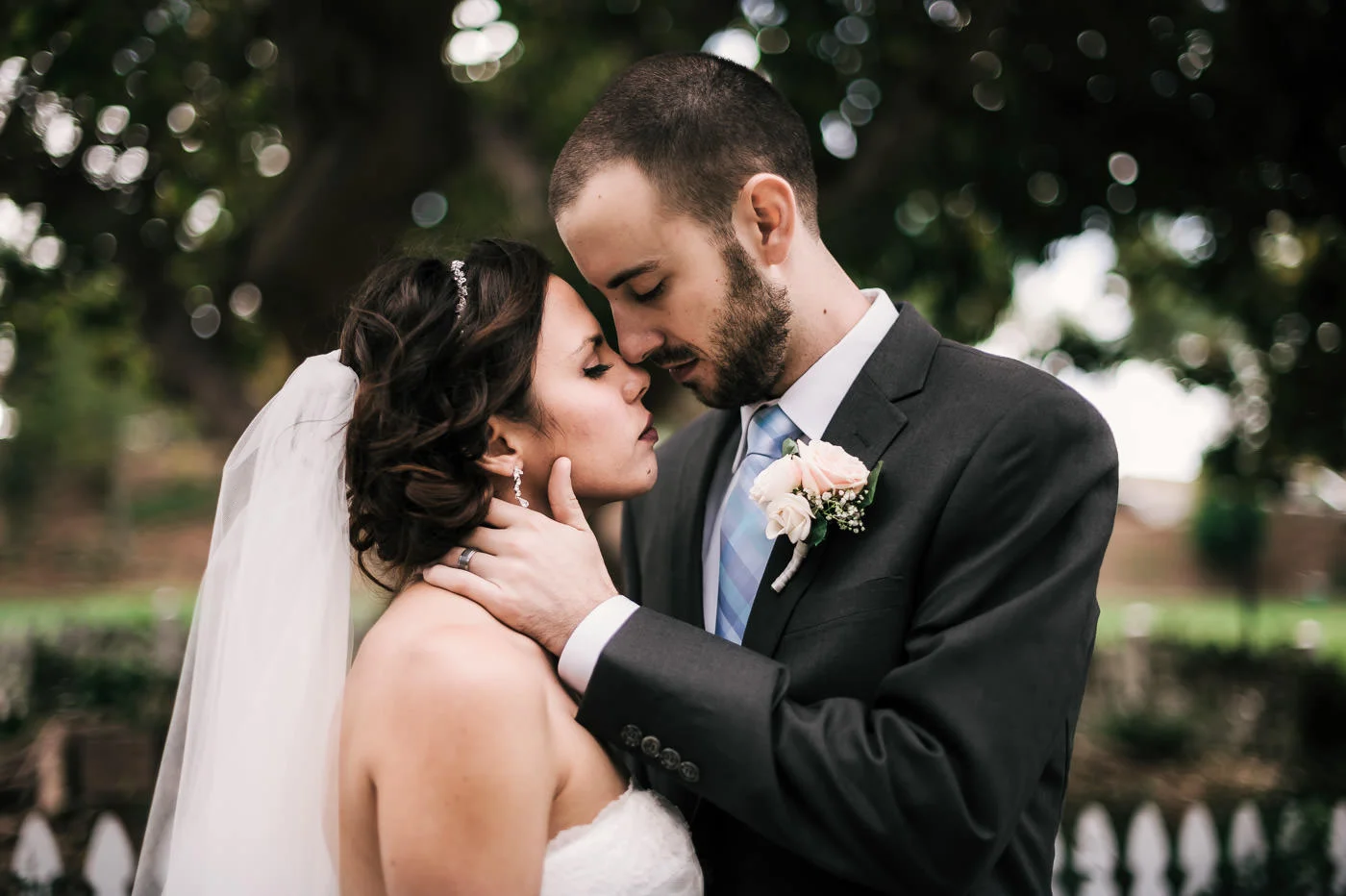 Couple gets lost in their romance and snuggles close after their San Diego wedding.