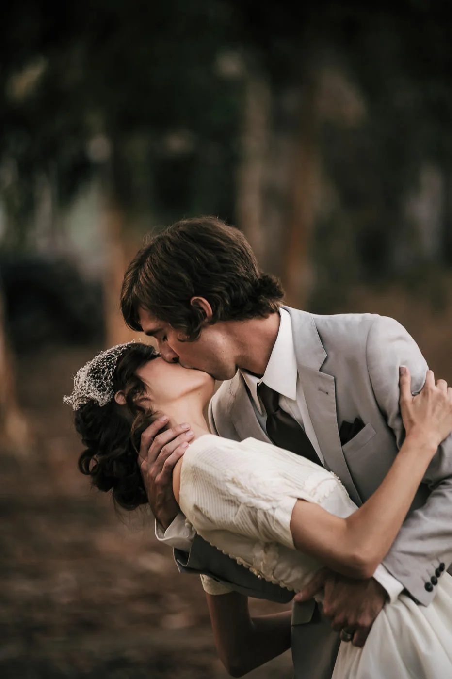 Bride and groom share a passionate kiss full of romance at their vintage wedding in temecula