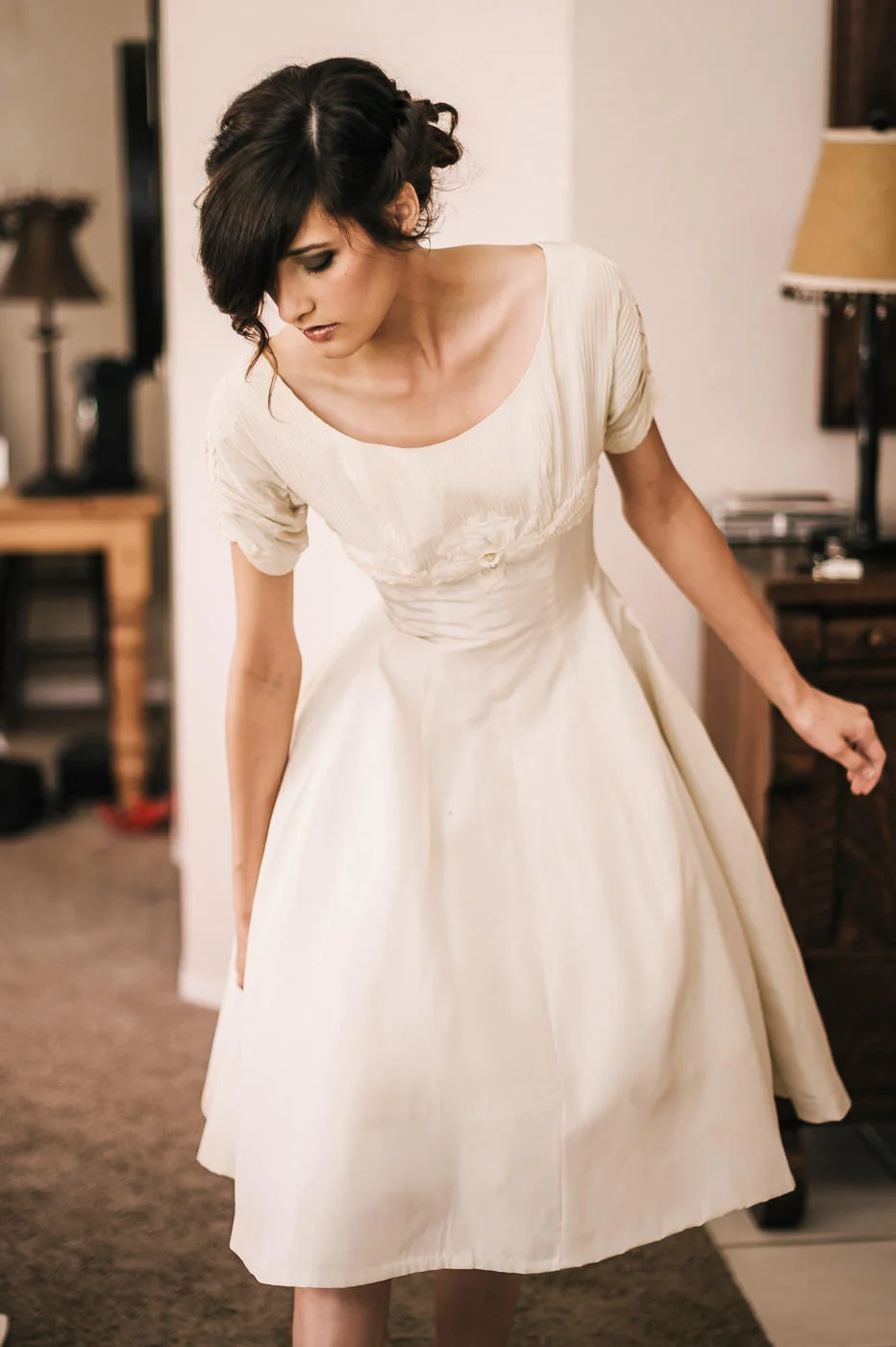 Bride puts on a vintage dress from her grandmother while getting ready for her romantic Temecula wine coutnry wedding