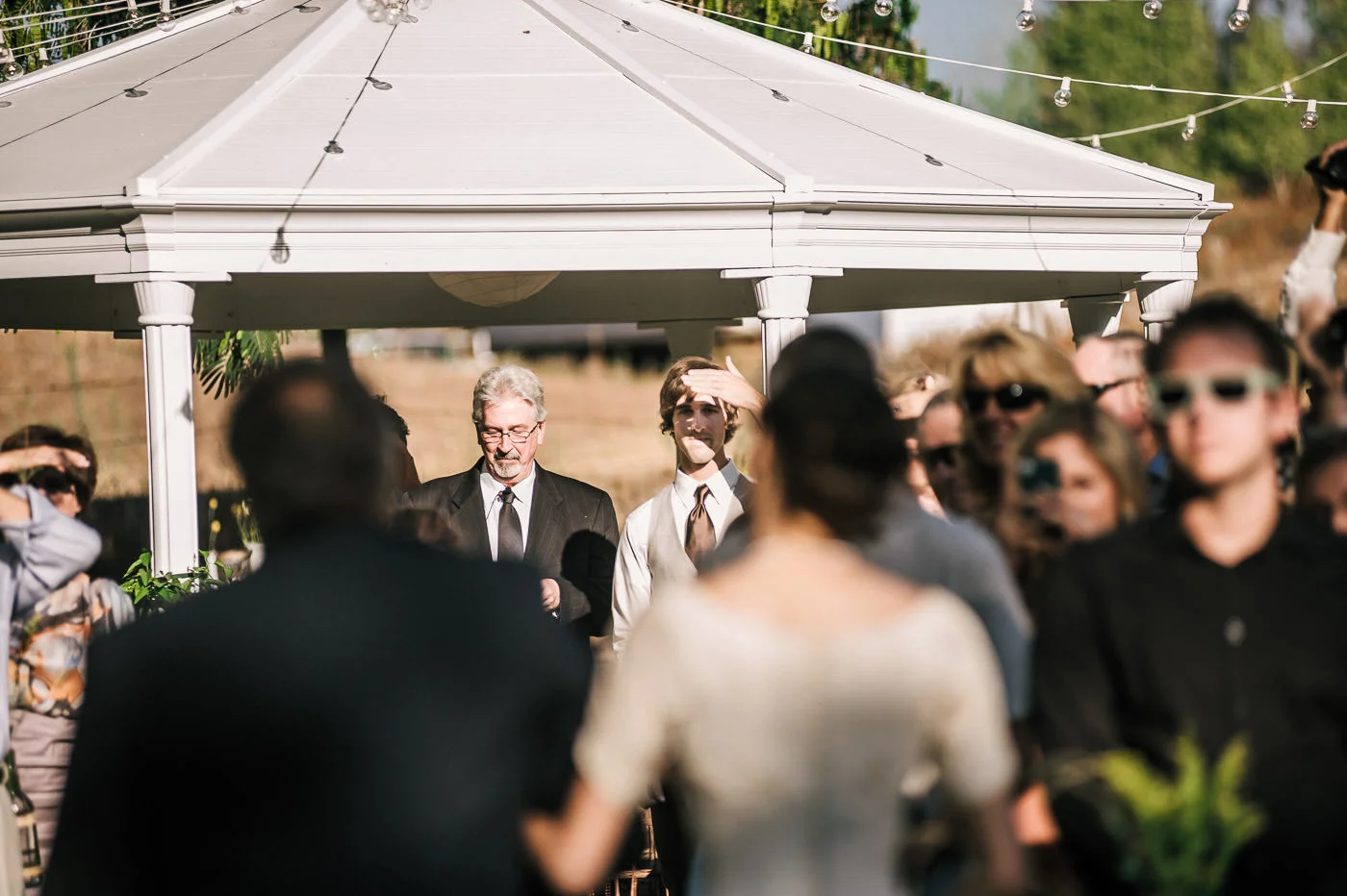 Groom sees the love of his life for the first time coming down the aisle at their romantic wine country wedding in Temecula california