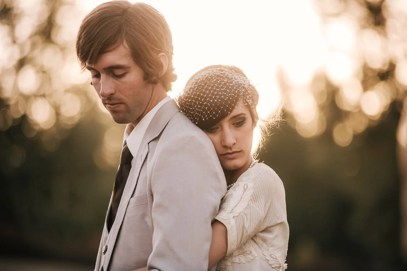 Bride and groom reflect back on their wonderful wedding as the sun sets behind them.