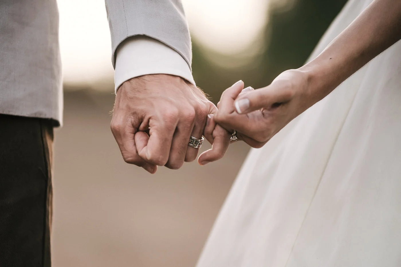 Bride and groom pinky promise to love each other forever