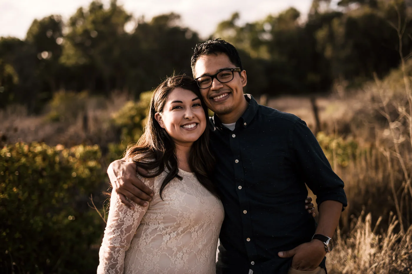 Happy couple has their photographs taken by their engagement photographer in El Matador State Beach, malibu.