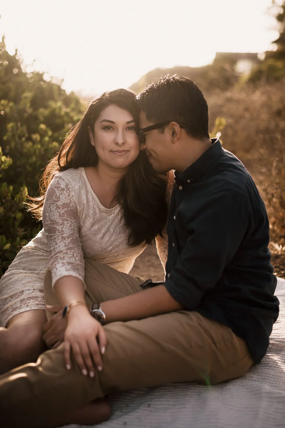 Sunset portrait of a loving couple atop the majestic cliffs of Malibu's El Matador State Beach in California.