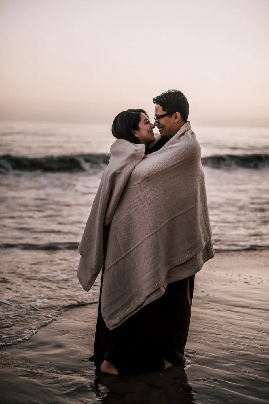 The cold winter weather couldnt deter this romantic couple from having their engagement session on the wet sand of El Matador State Beach.