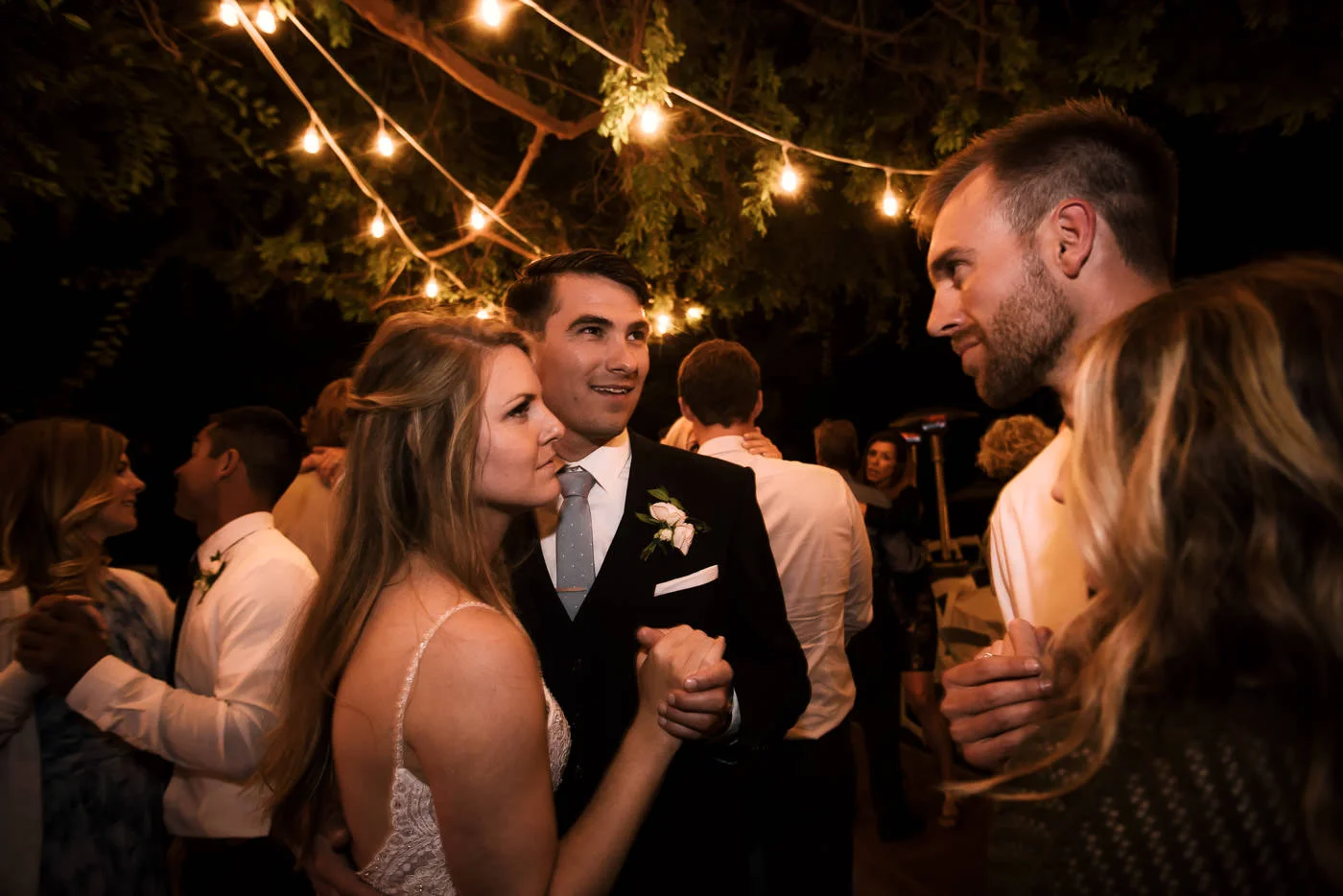 Couples hit the dance floor for a roamntic slow dance and chat with the bride and groom.