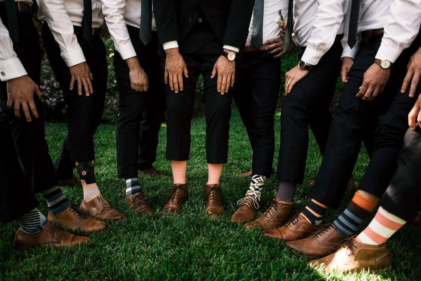 Groom and his groomsmen show off their crazy socks and stylish shows captured by a Temecula wedding photographer.